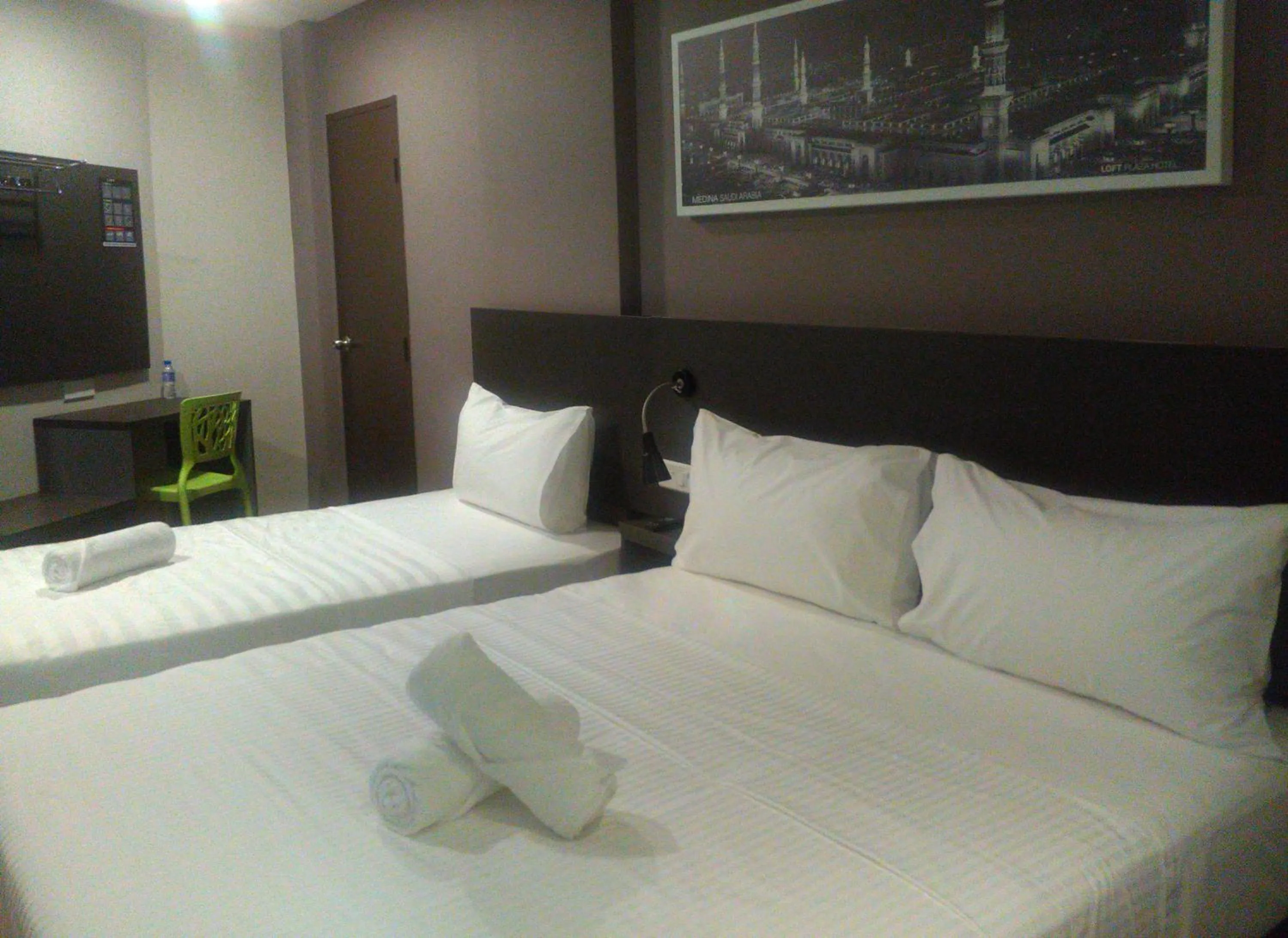 Bed in The Loft Plaza Hotel