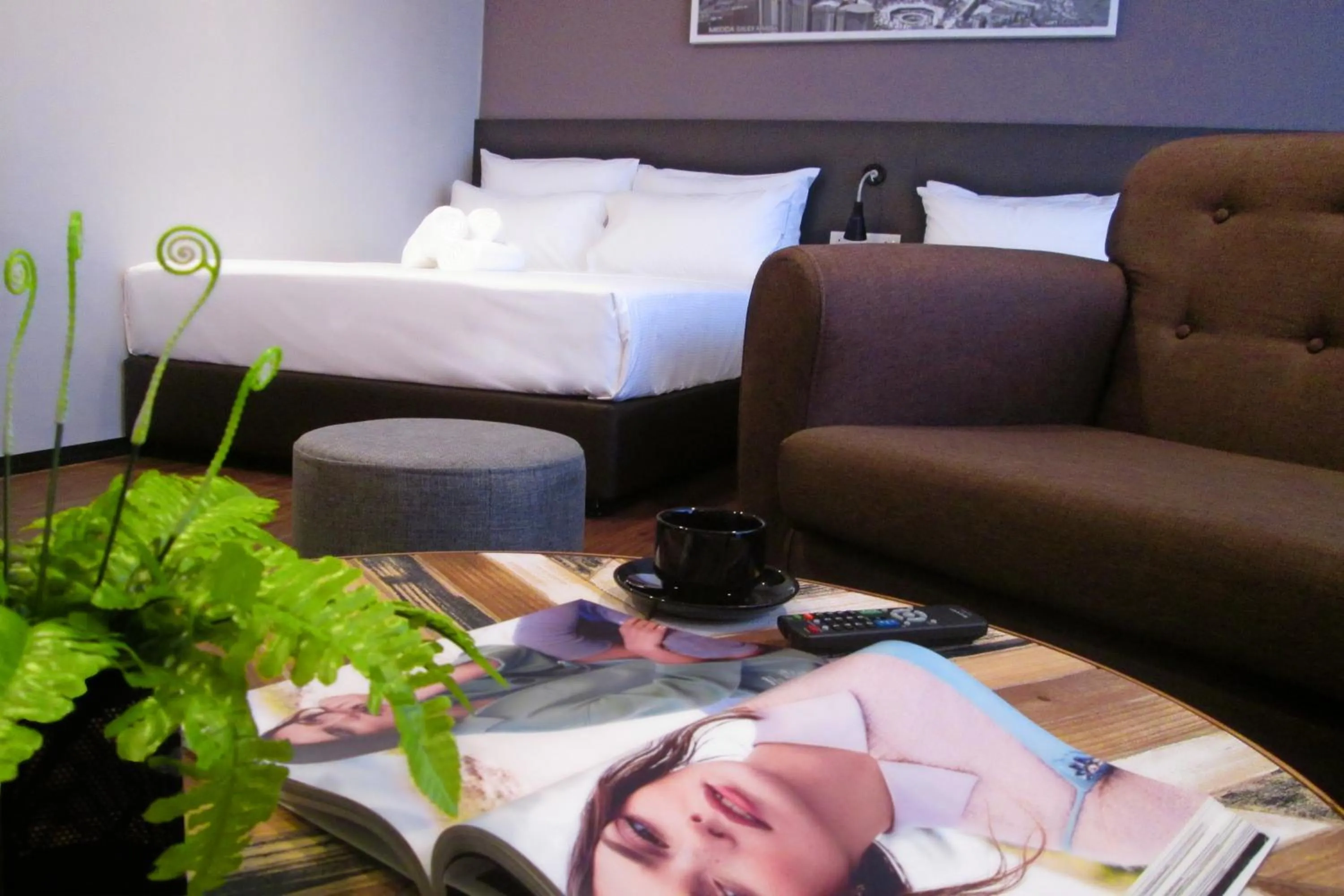 Bed in The Loft Plaza Hotel