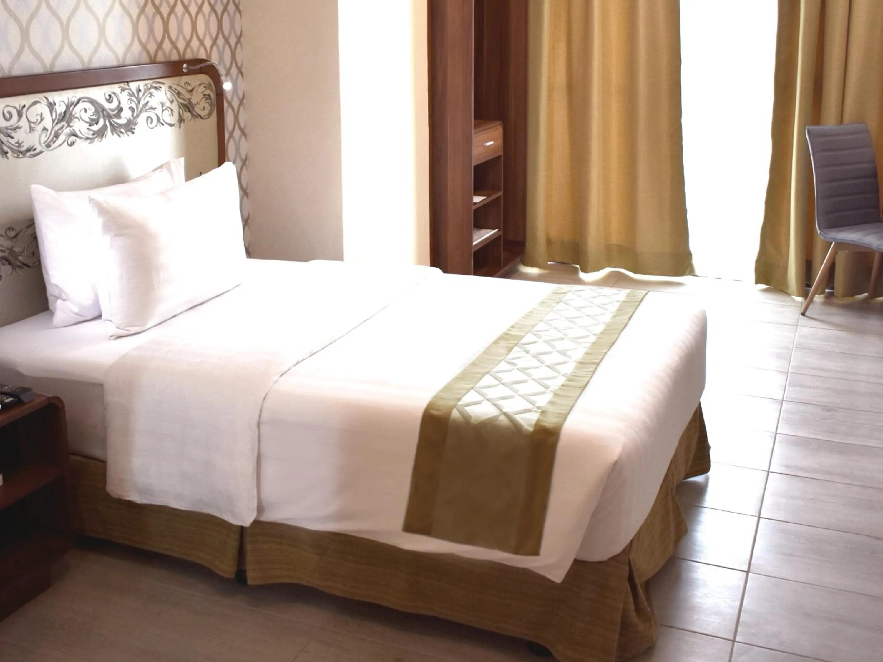 Bedroom, Bed in One Central Hotel & Suites