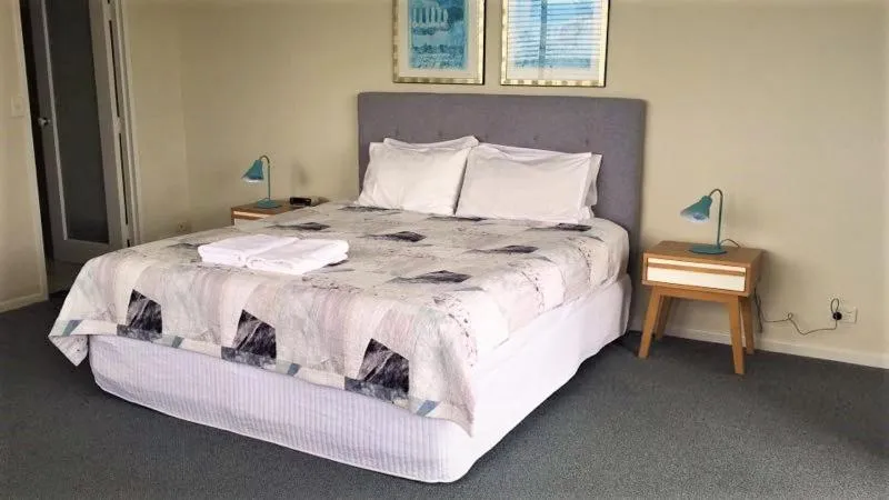 Bed in The Penthouses Apartments