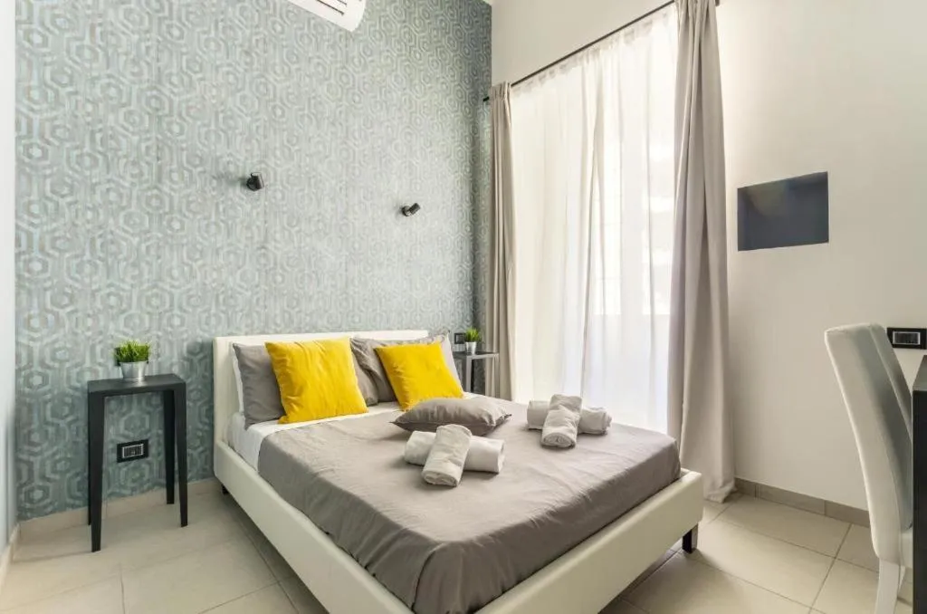 Bed in Merulana 139 Suites