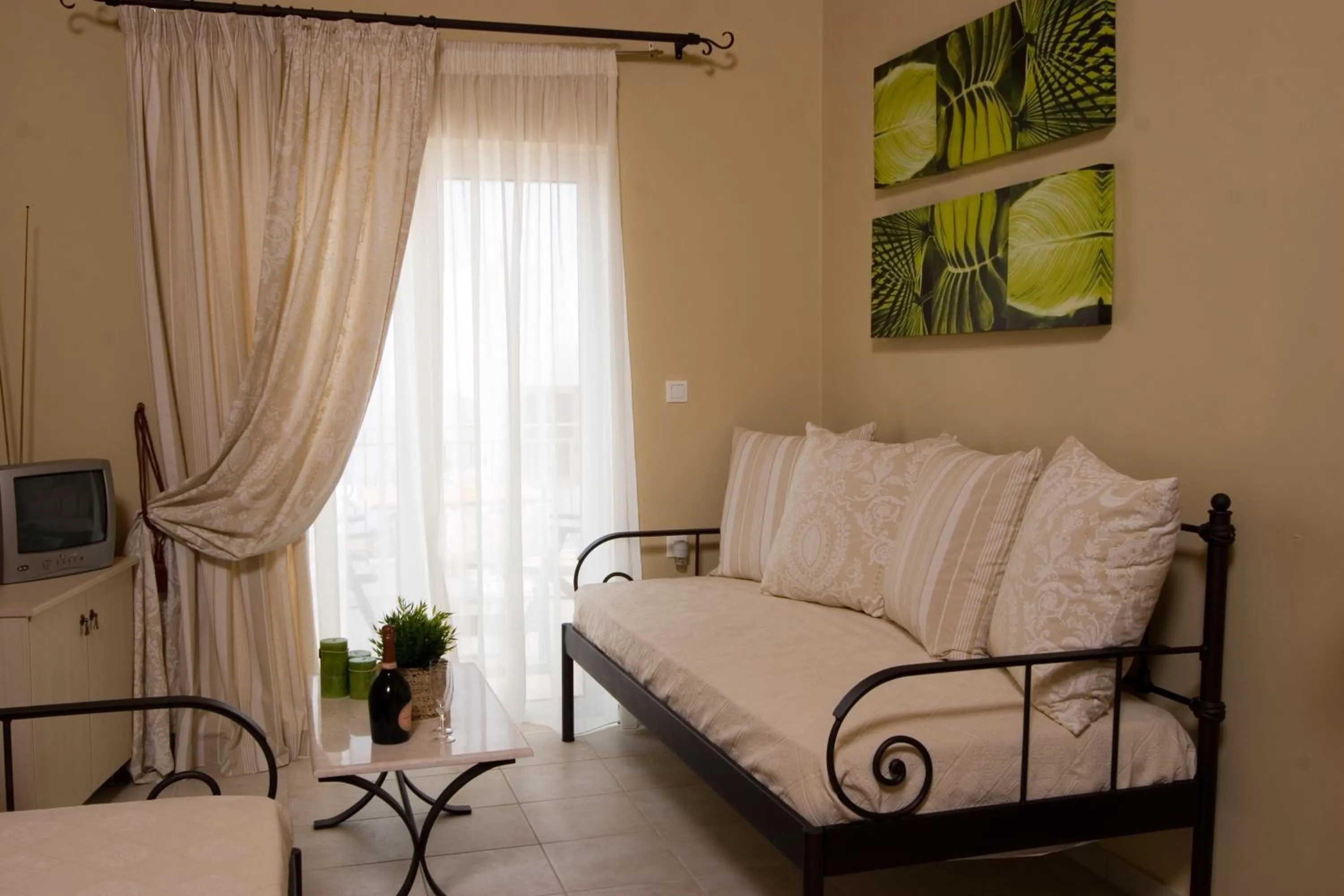 Communal lounge/ TV room, Bed in Oasis Beach Hotel