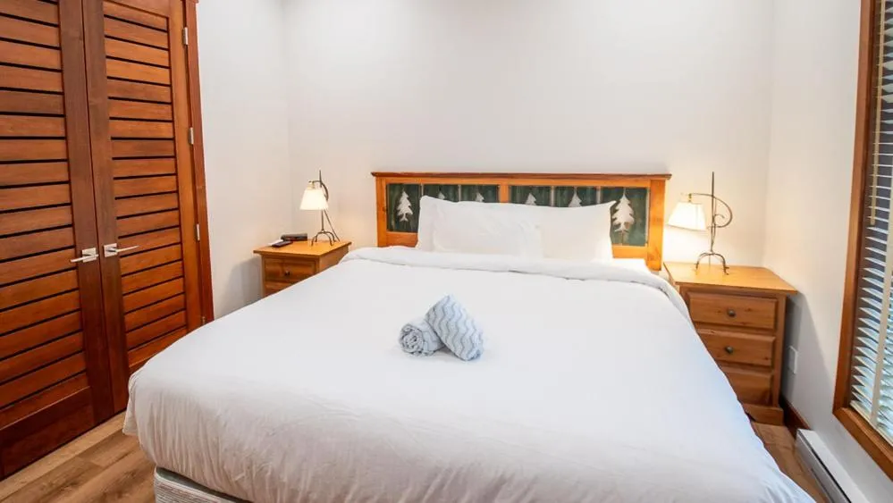 Bed in Snow Creek Lodge by Fernie Lodging Co