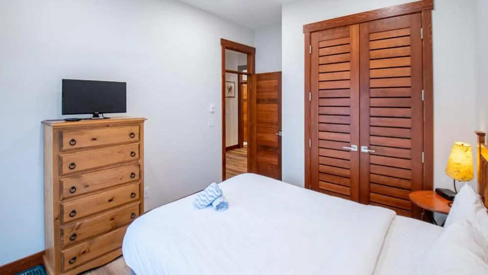 Bed in Snow Creek Lodge by Fernie Lodging Co