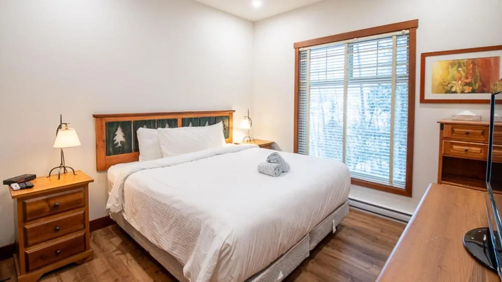 Bed in Snow Creek Lodge by Fernie Lodging Co