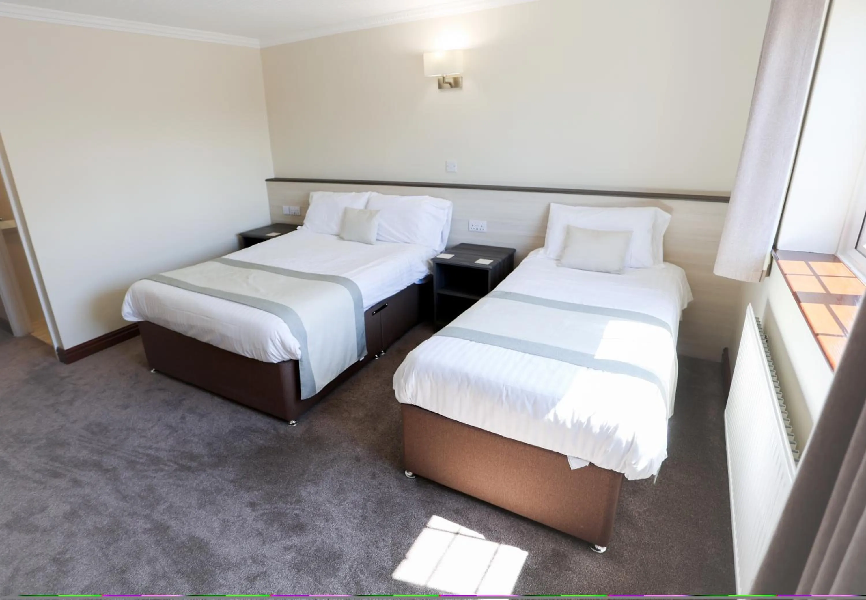 Bed in The Appleby Inn Hotel