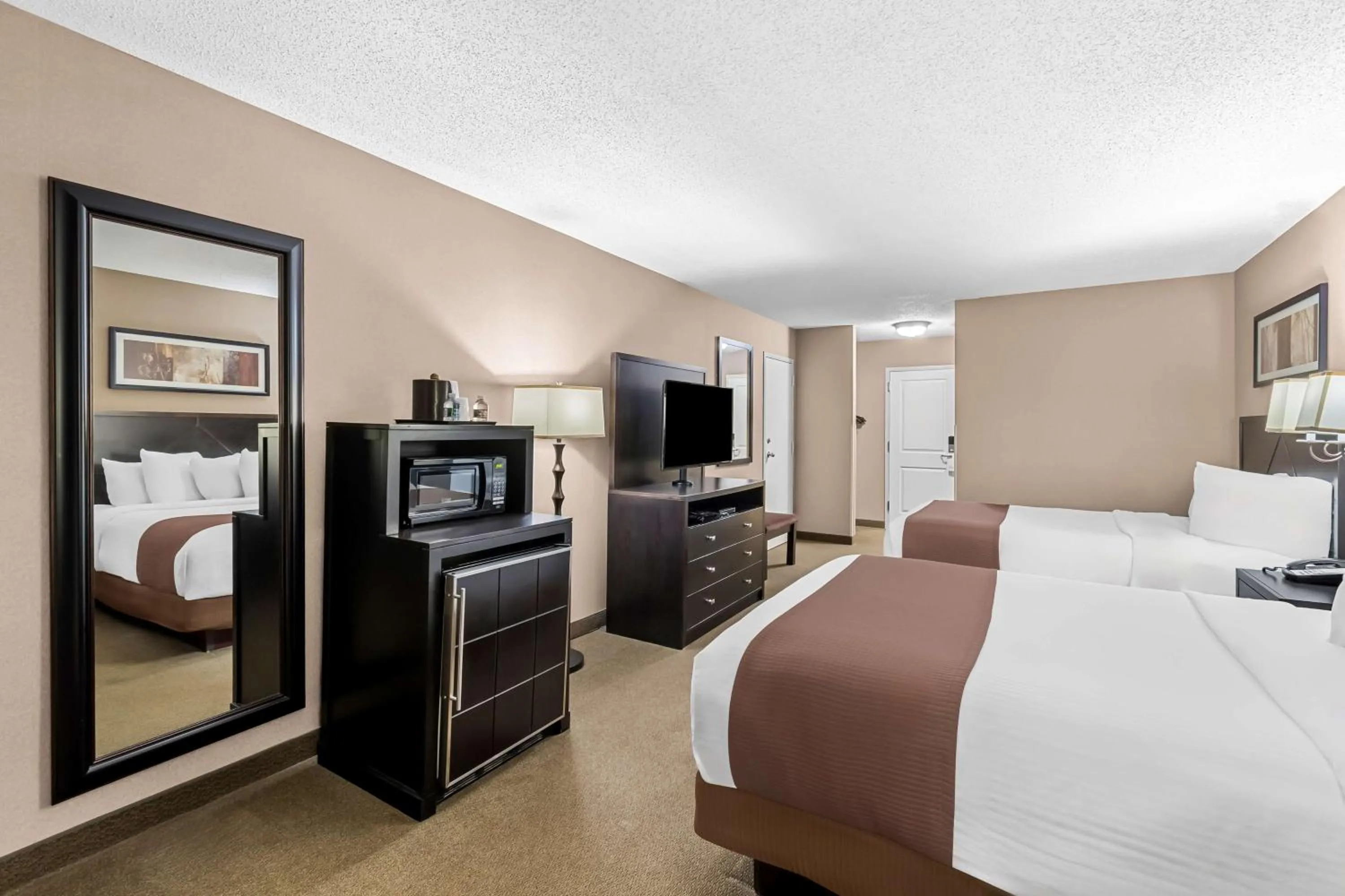 Bedroom, Bed in Heartland Inn & Suites, SureStay Collection by Best Western
