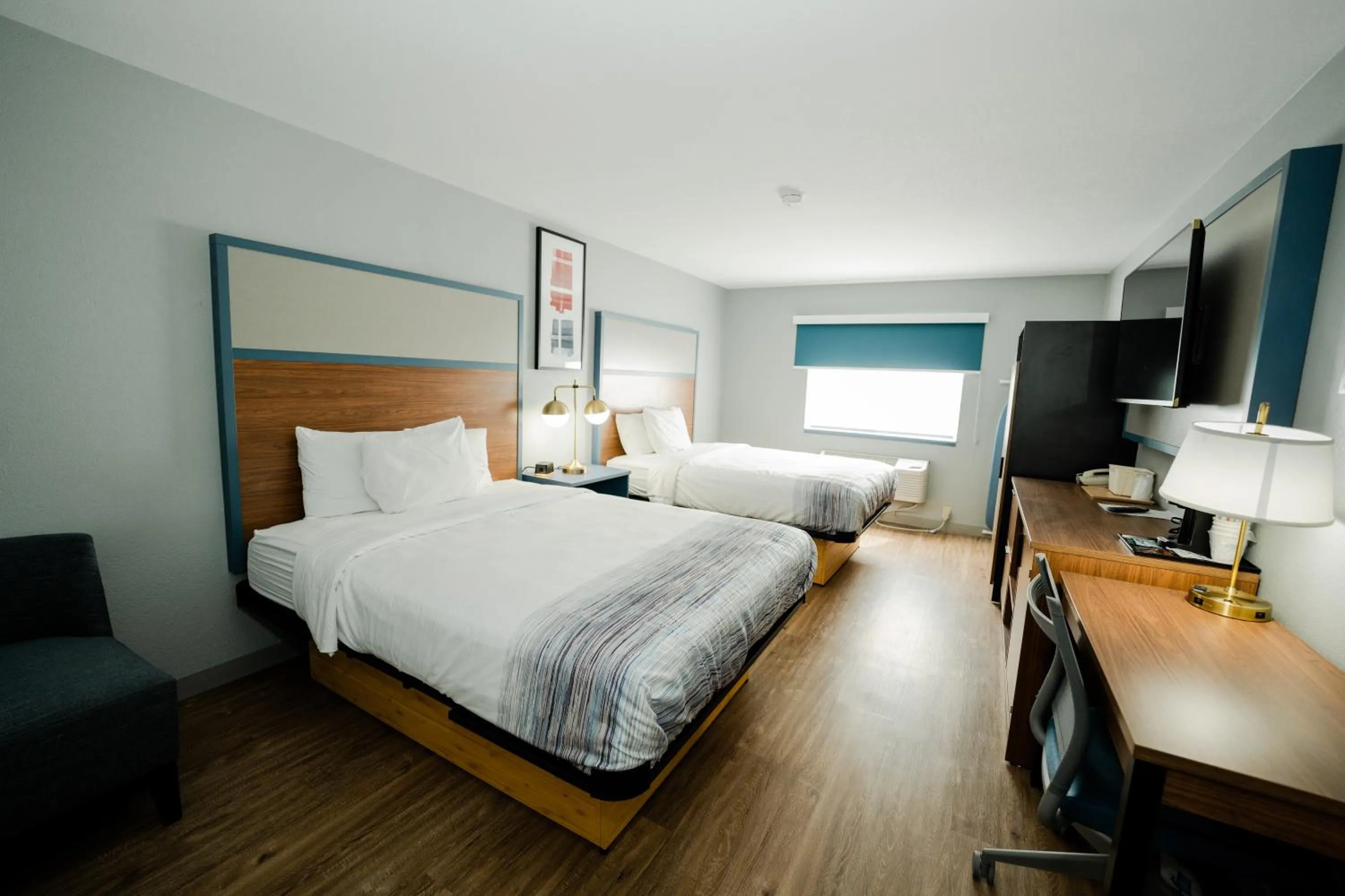 Bed in AmericInn by Wyndham Tomahawk