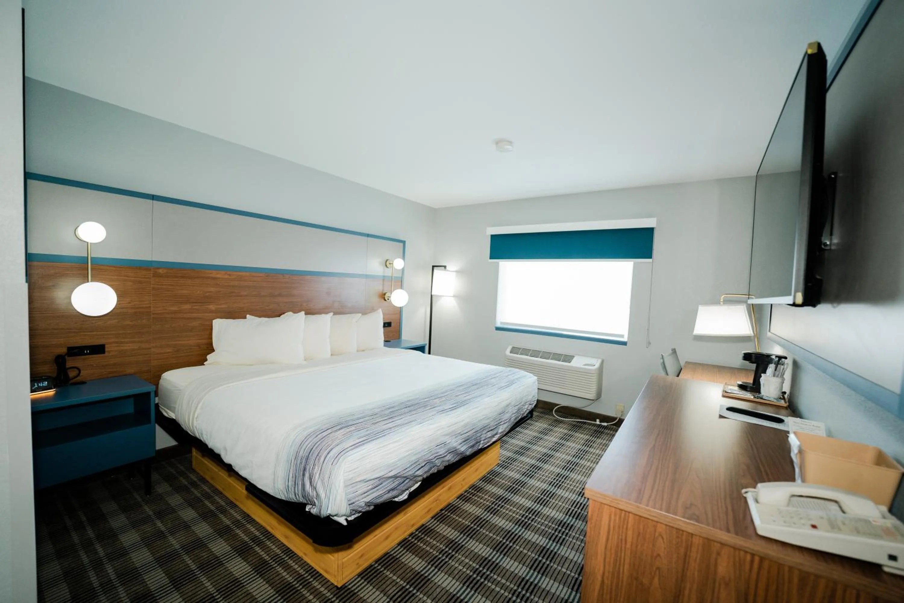 Bed in AmericInn by Wyndham Tomahawk