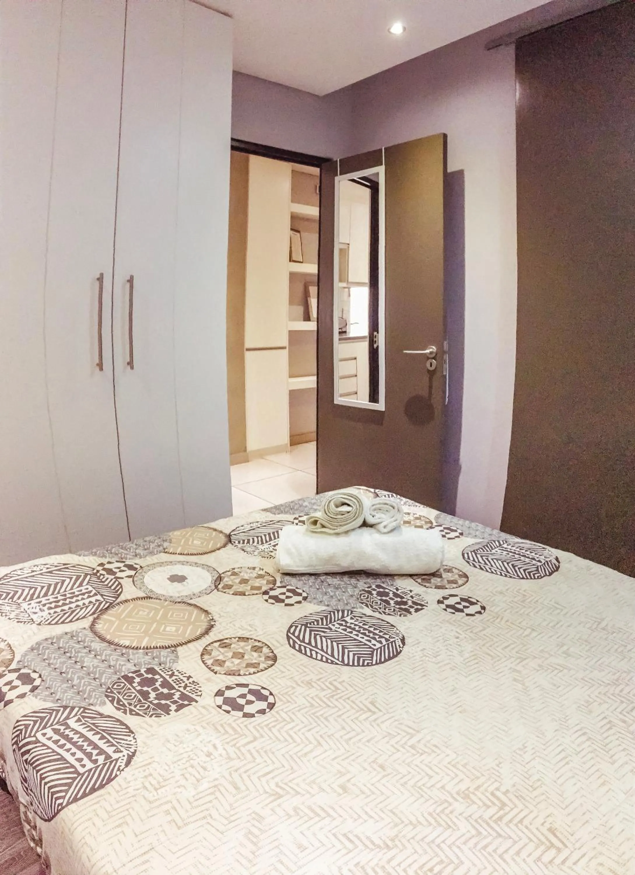 Bed in Elegant Wild Olive Apartment at Grove Mall