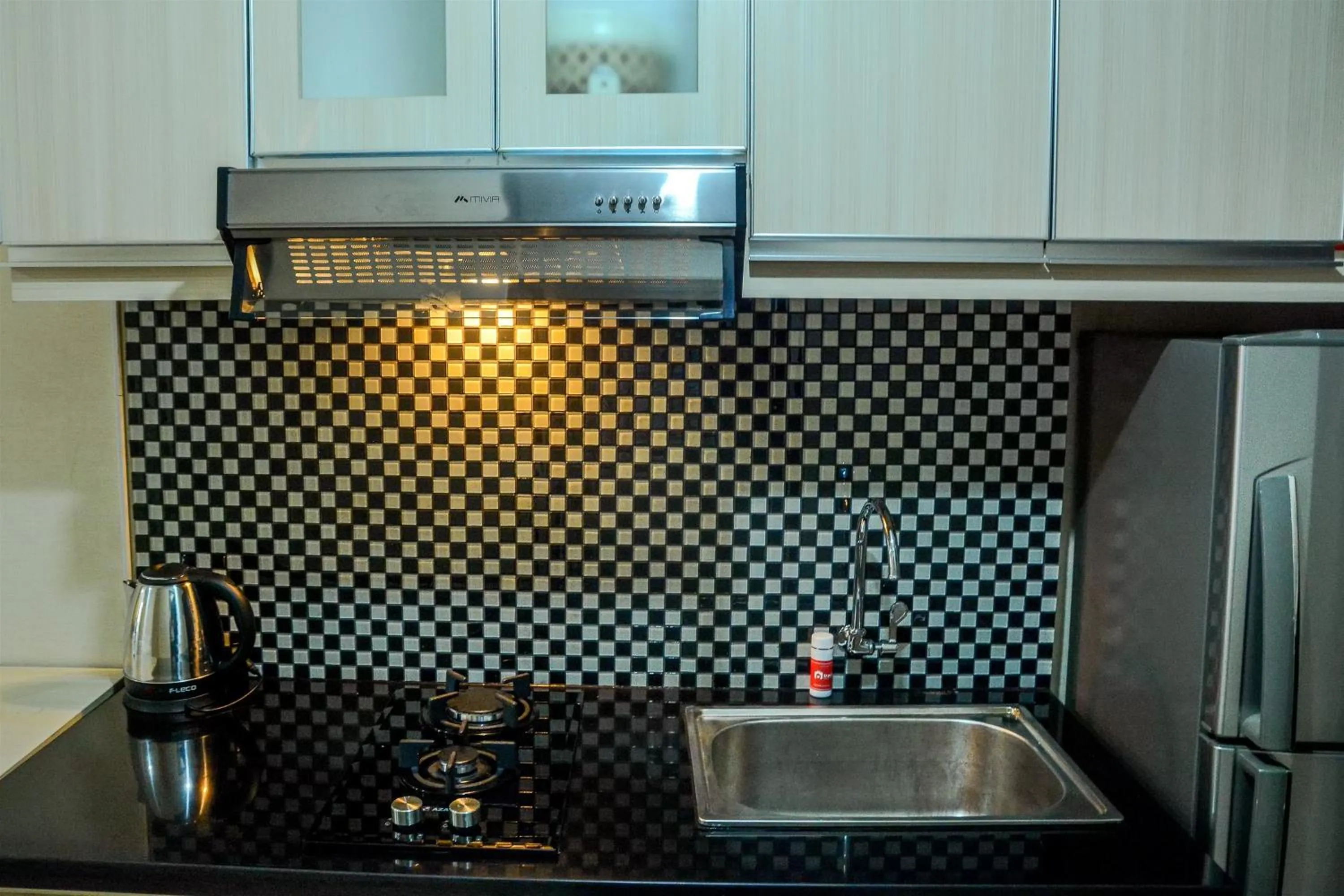 Minimalist Studio Room at Grand Serpong Apartment By Travelio