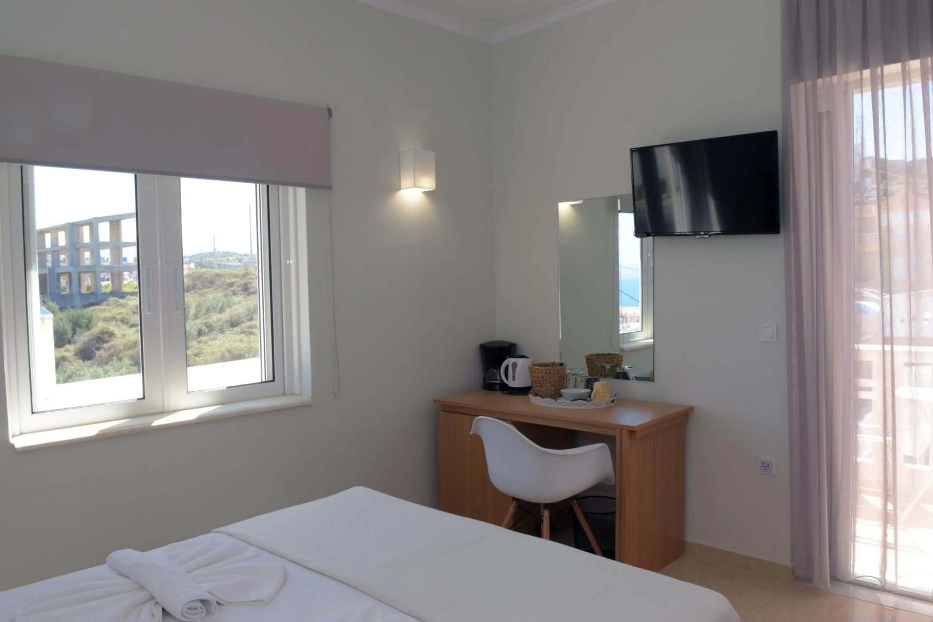 Bed in Mithos Premium Rooms