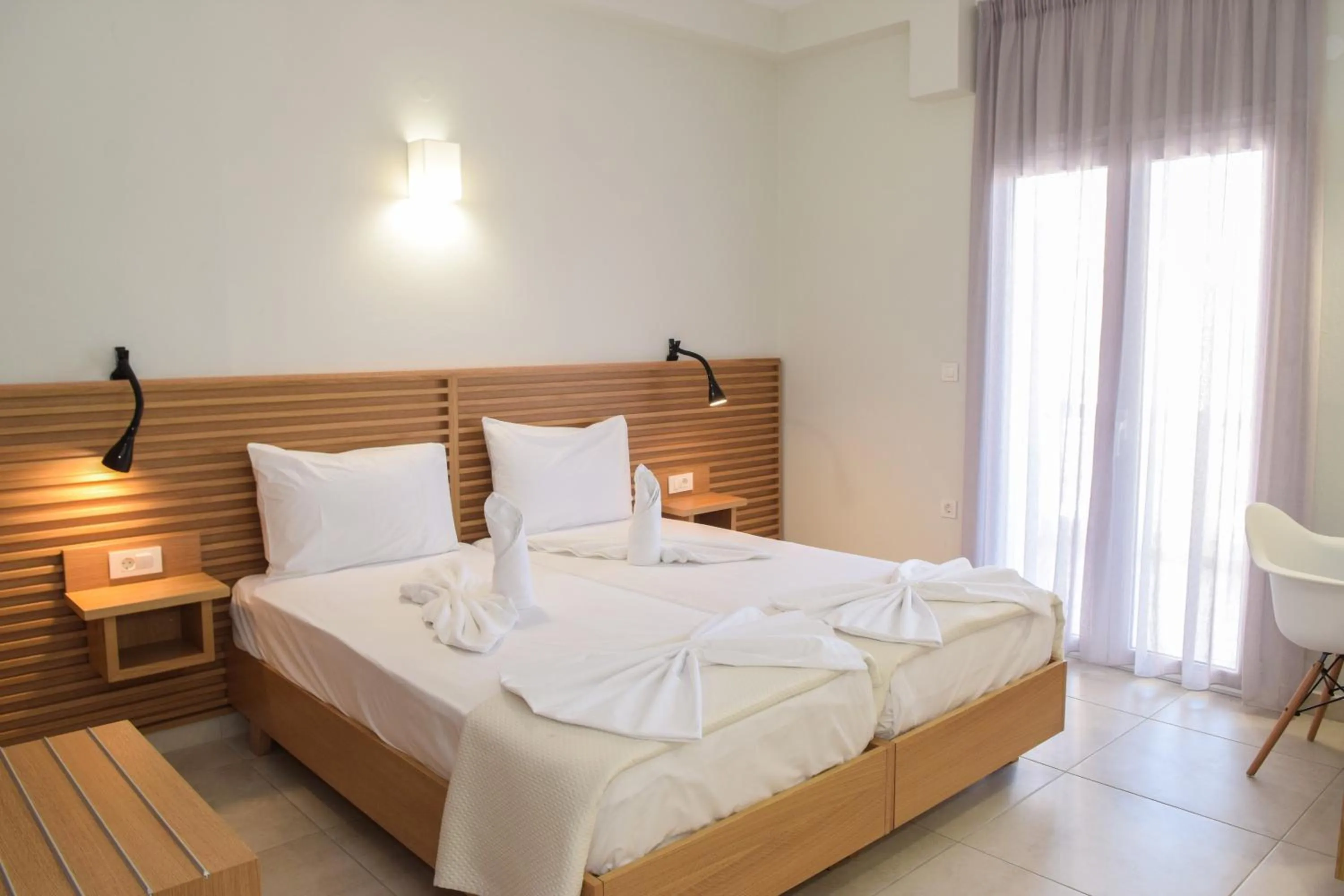 Bed in Mithos Premium Rooms