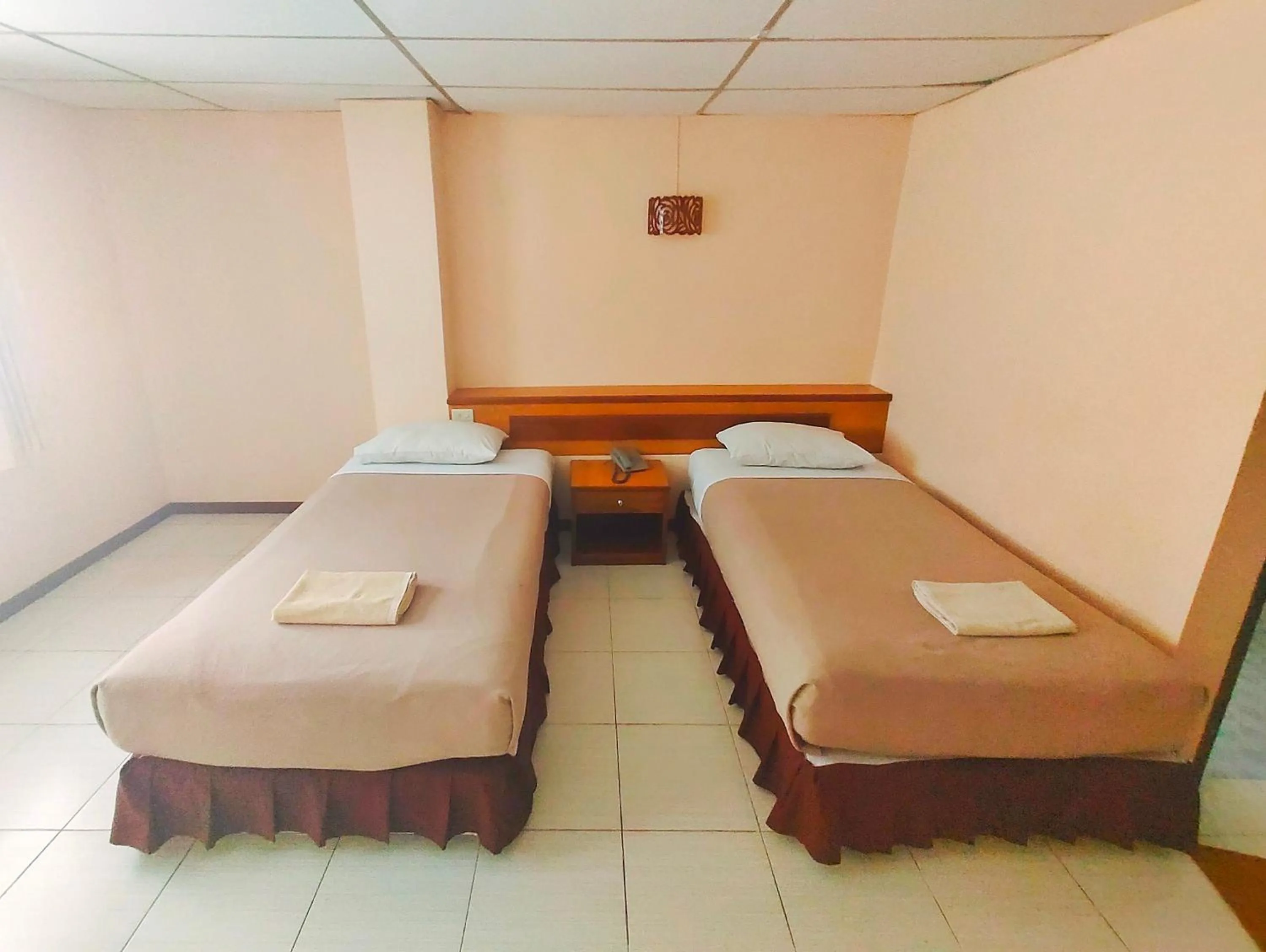 Bed in Top Thai Hotel