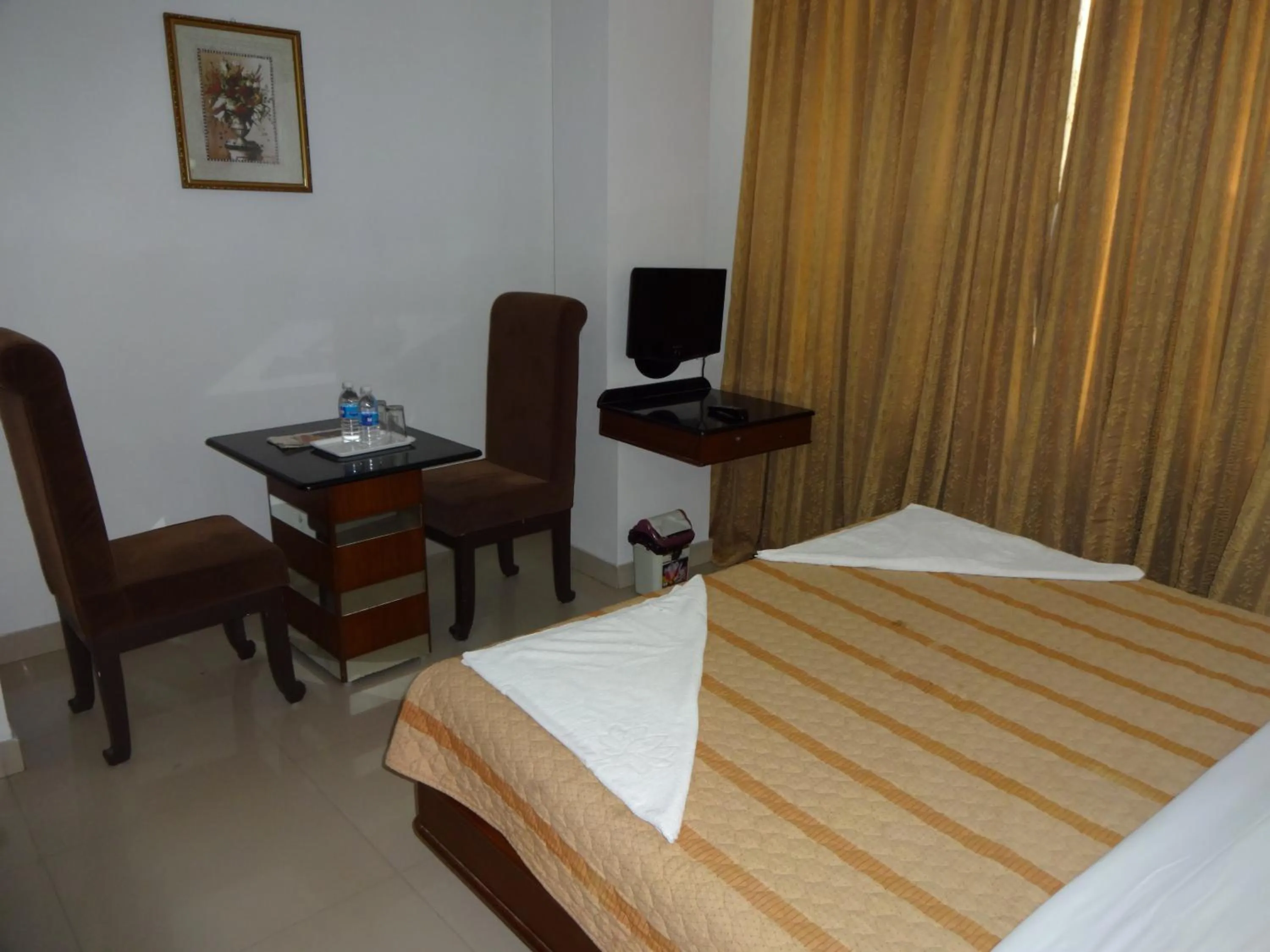 Photo of the whole room, Bed in Lotus Comfort - A Pondy Hotel