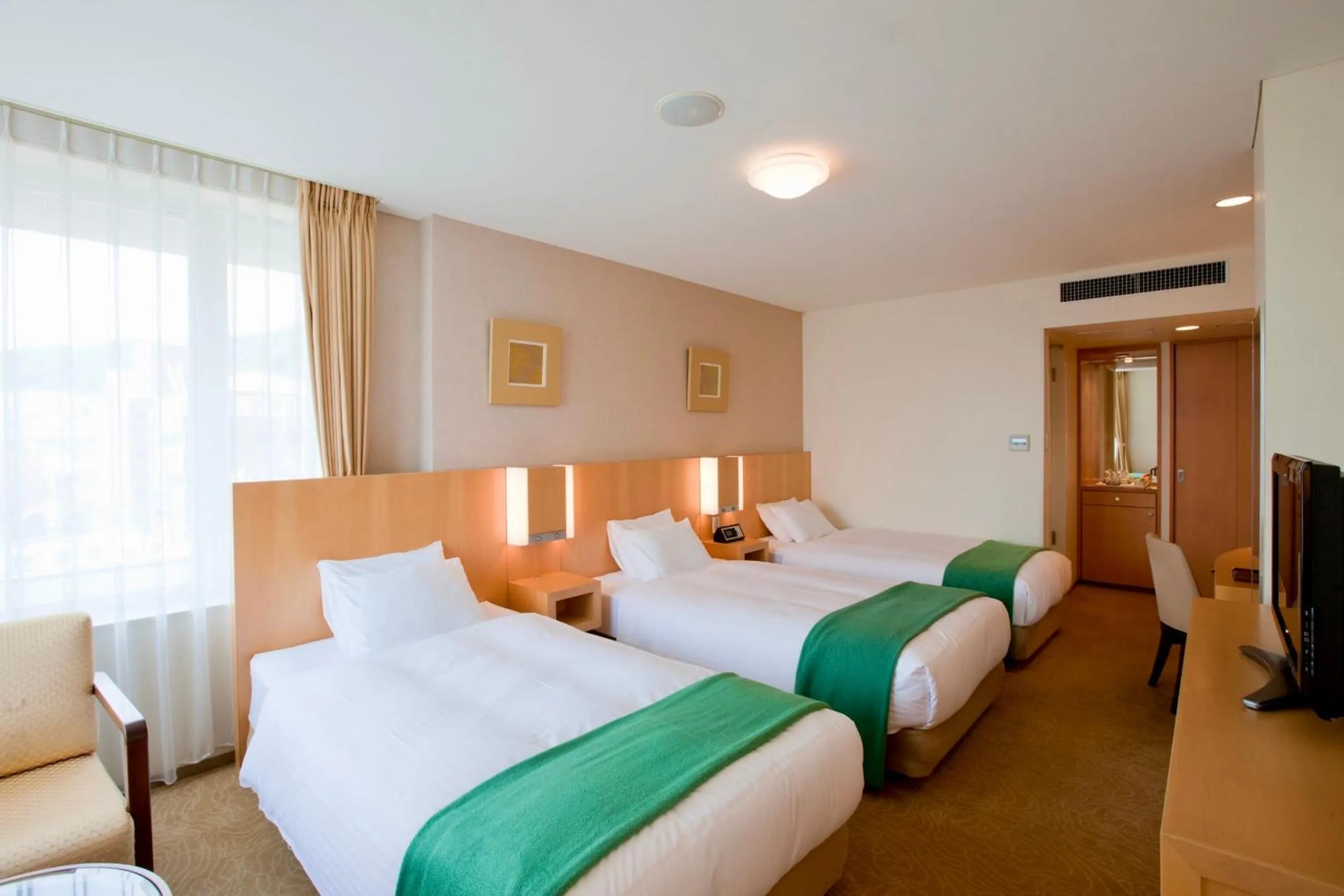 Bed in Hotel Kitano Plaza Rokkoso