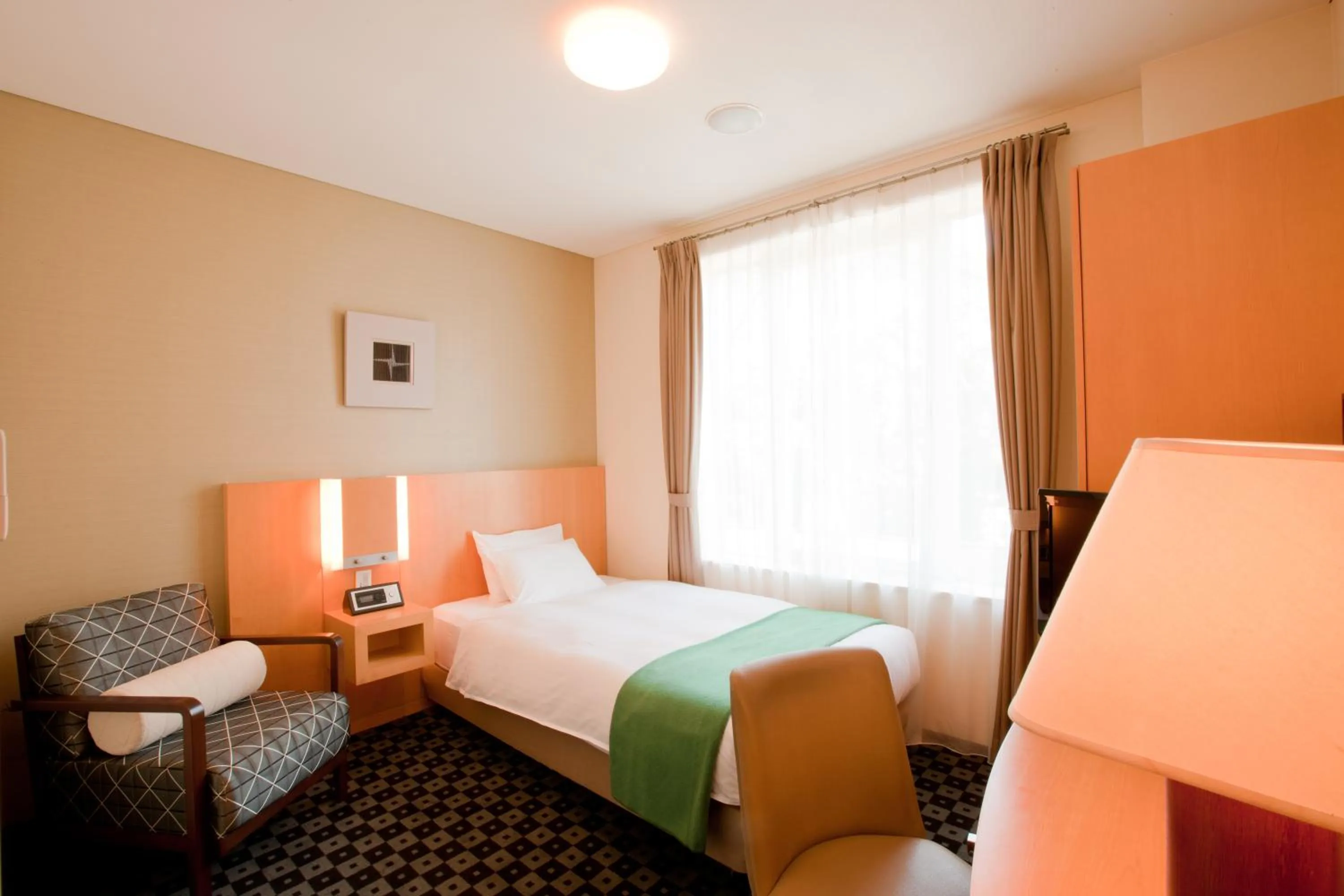 Bed in Hotel Kitano Plaza Rokkoso