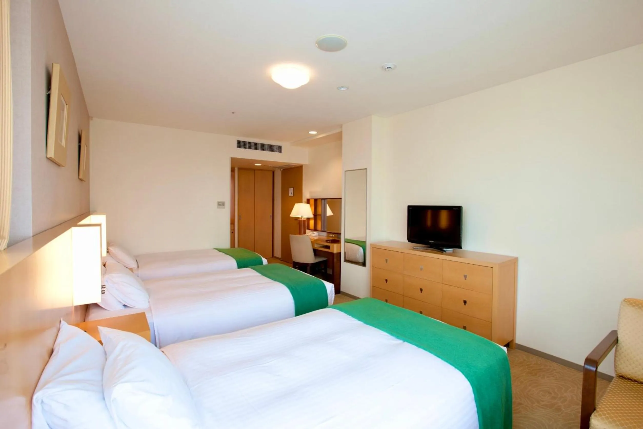 Bed in Hotel Kitano Plaza Rokkoso