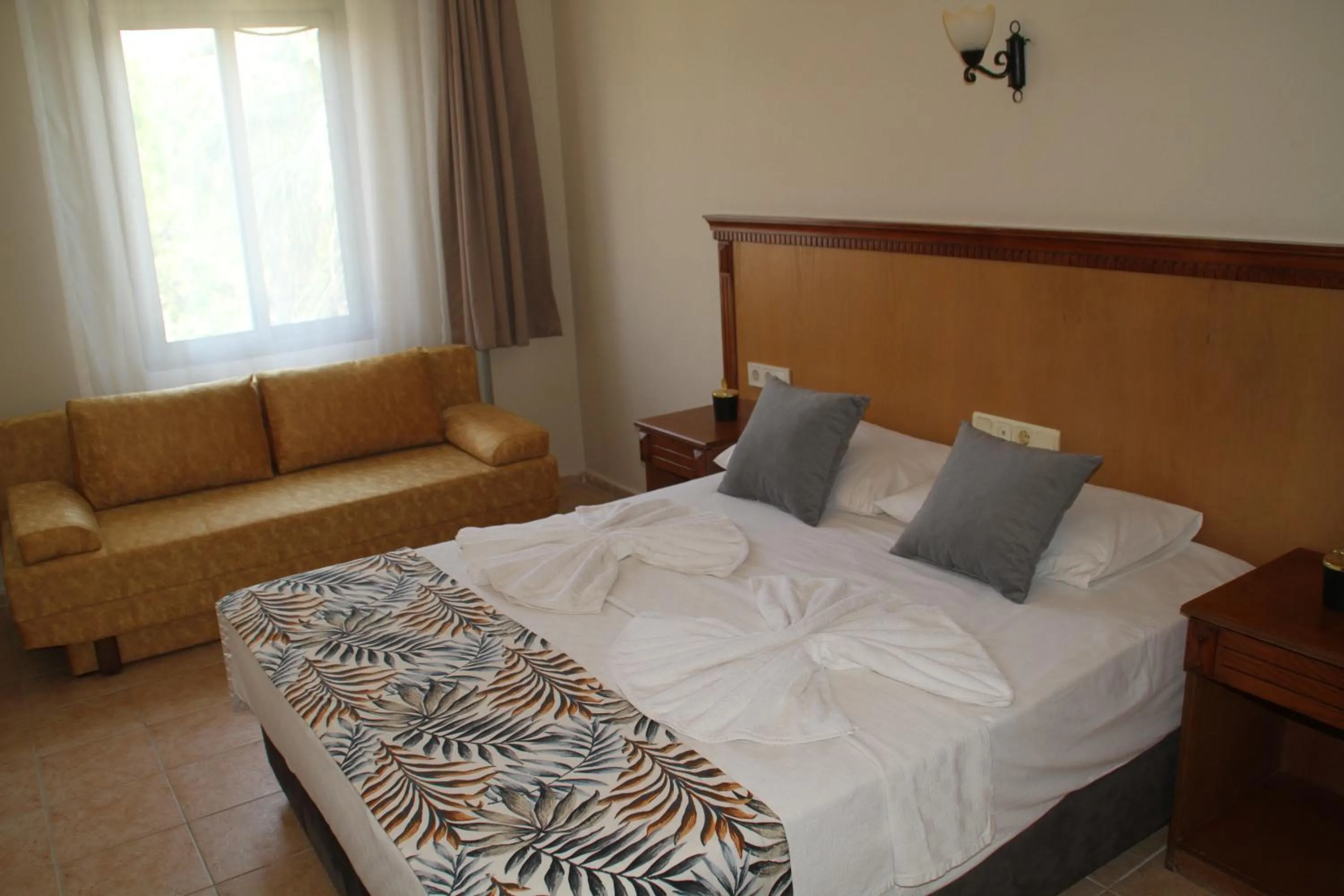 Bed in Rosy Suites Hotel