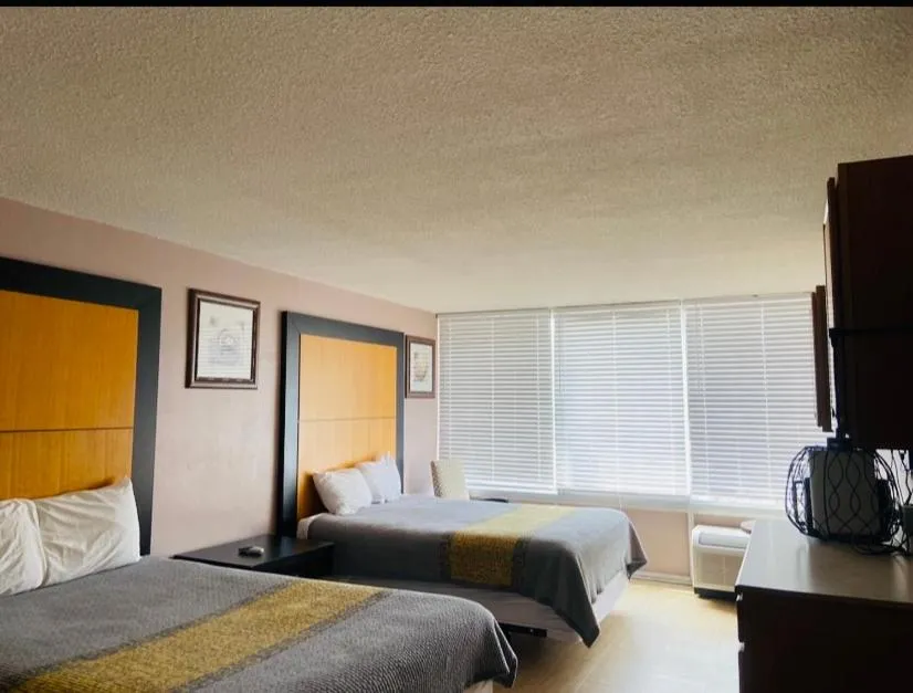 Bed in APM Inn & Suites