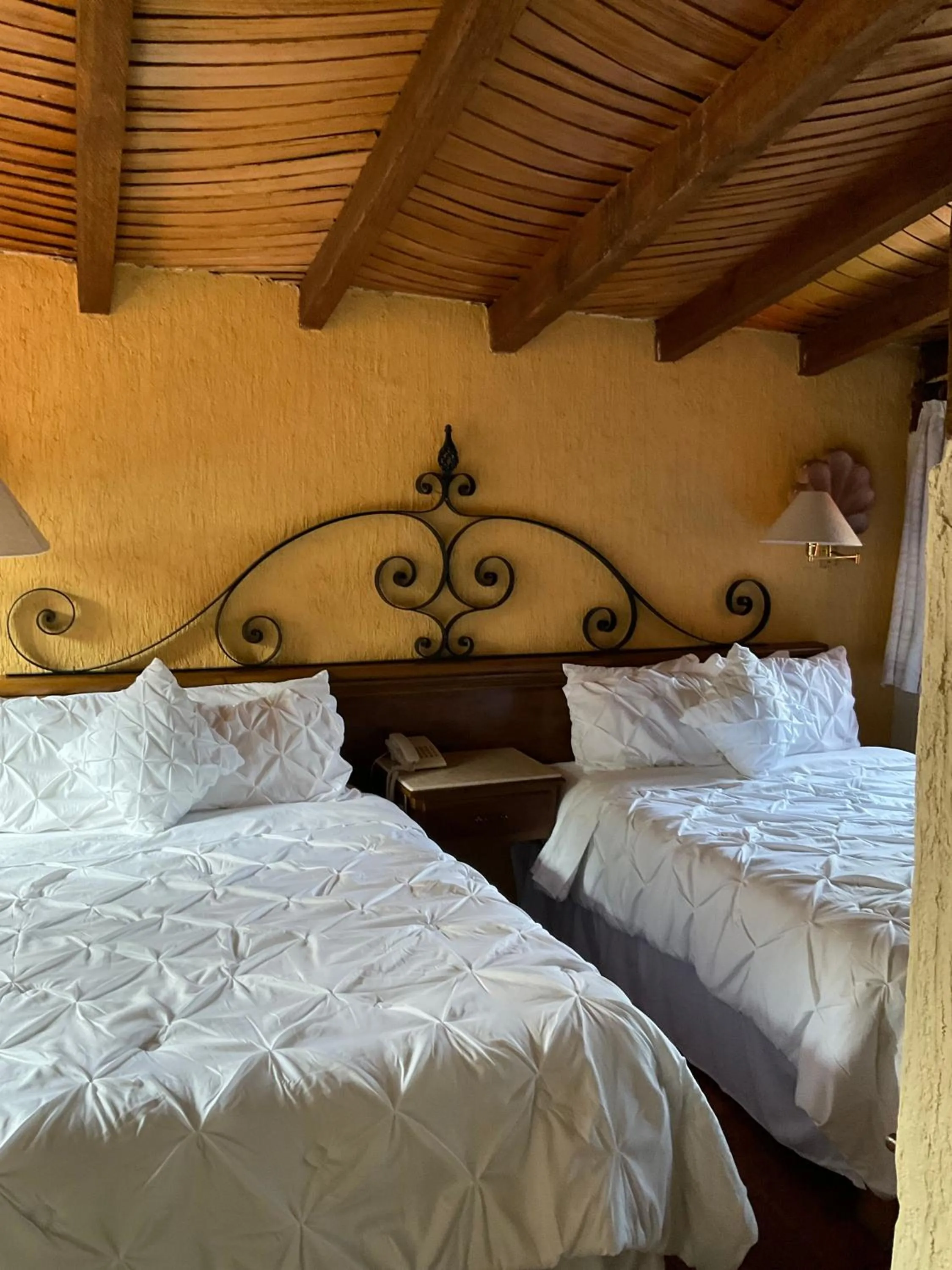 Bed in Villa San Jose Hotel & Suites