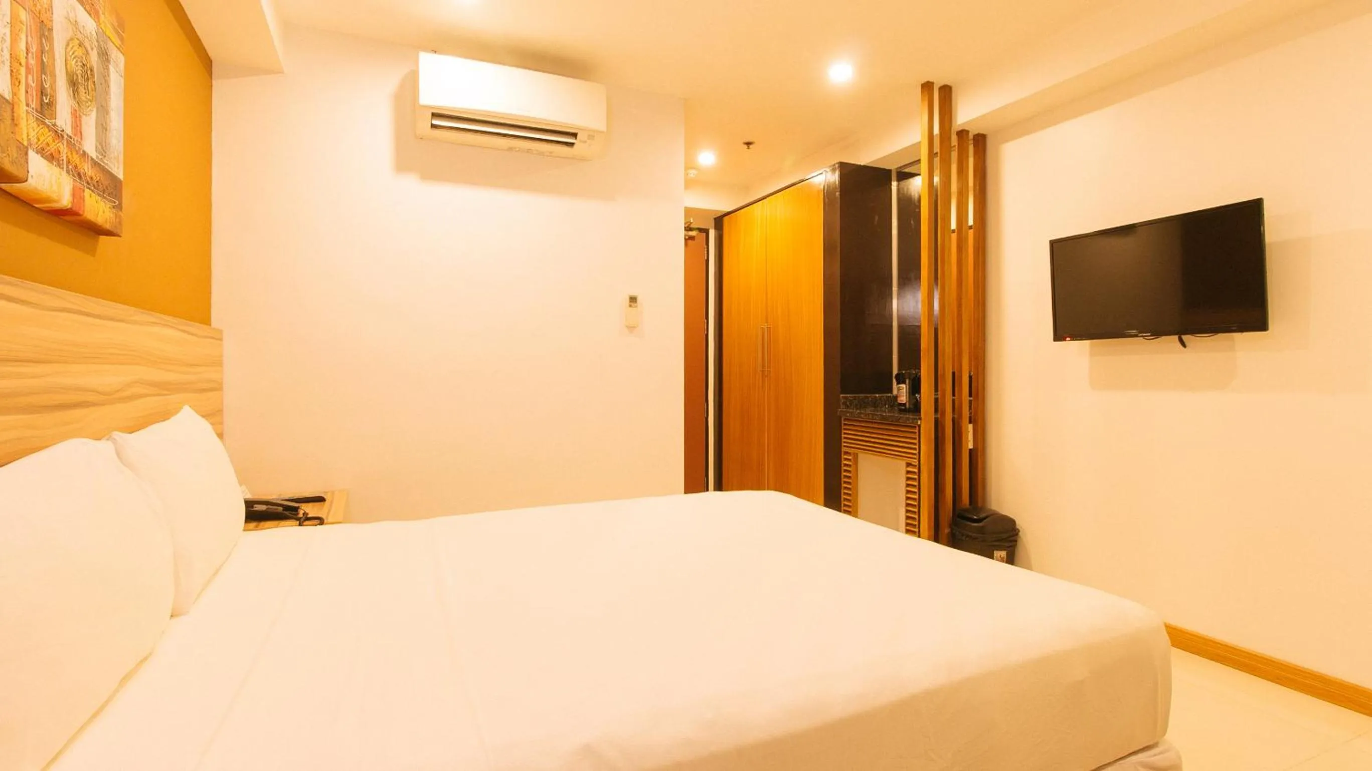TV and multimedia, Bed in Guijo Suites Makati
