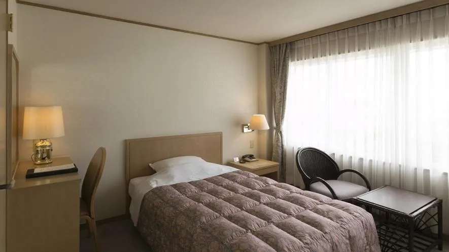 Bed in Kaike Grand Hotel Tensui