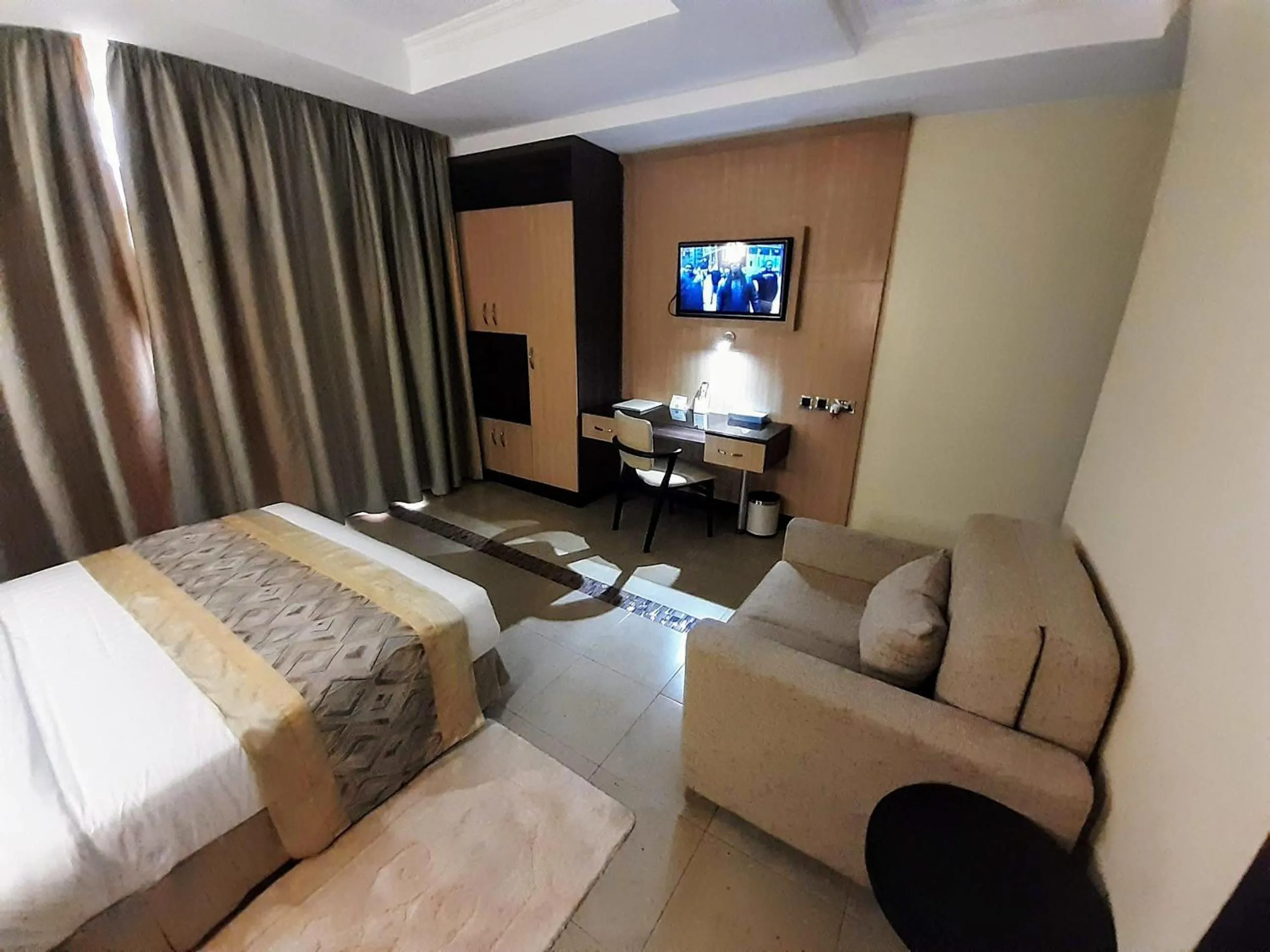 Communal lounge/ TV room, Bed in Elysian Resort