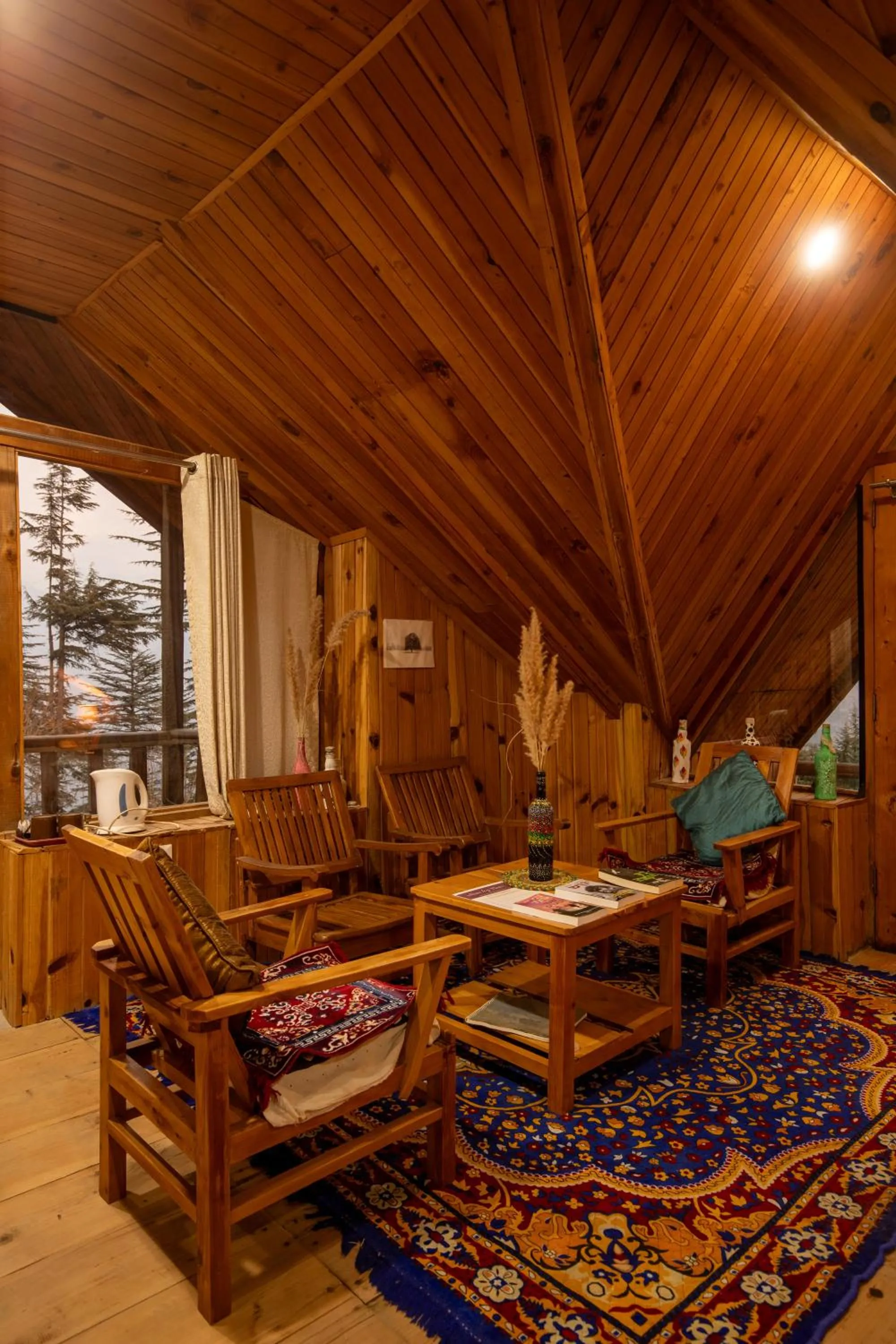 Seating area in Ishan Log Huts-A boutique home stay