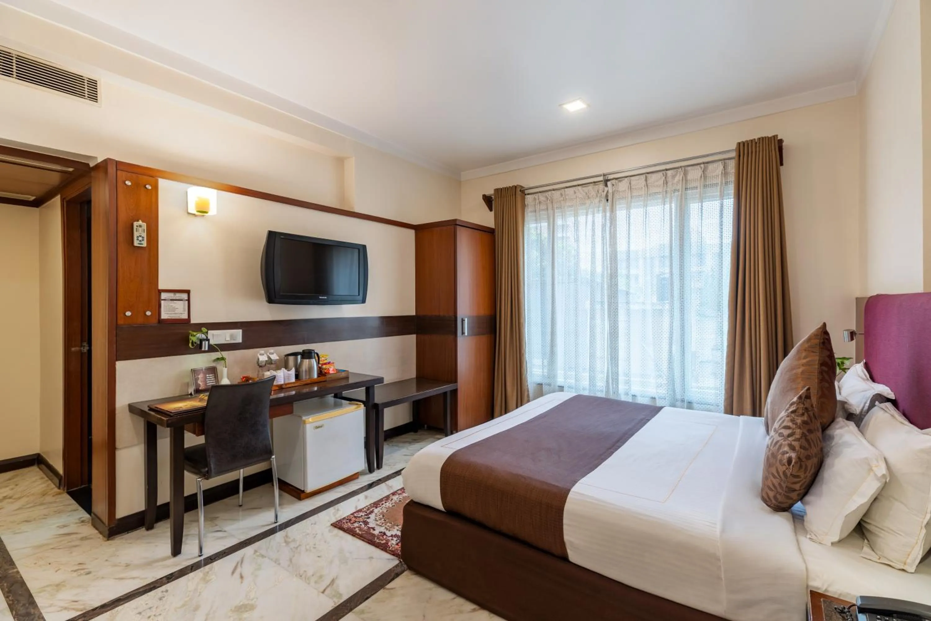 TV and multimedia, Bed in Amantra Comfort Hotel