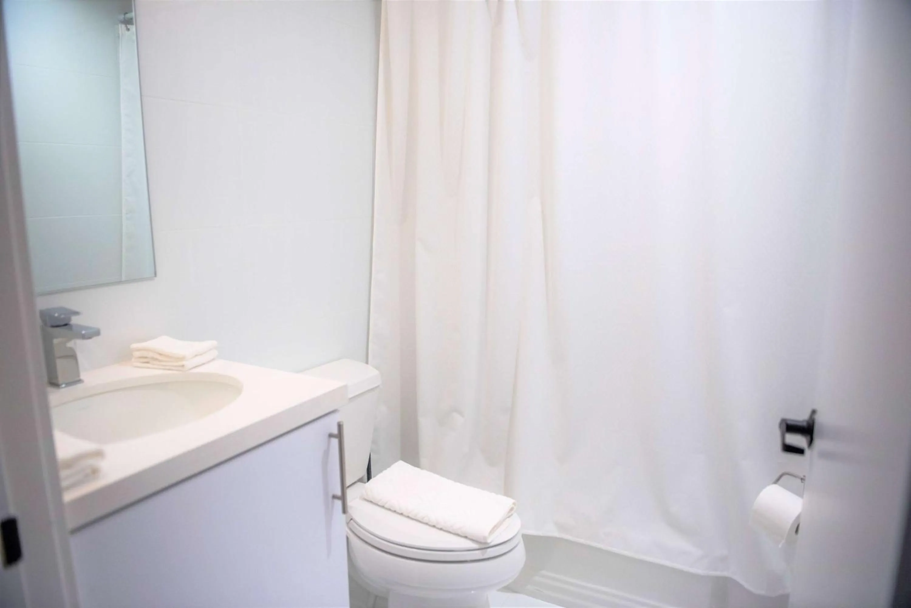 TV and multimedia, Bathroom in 12th & Ocean Suites by LuxUrban