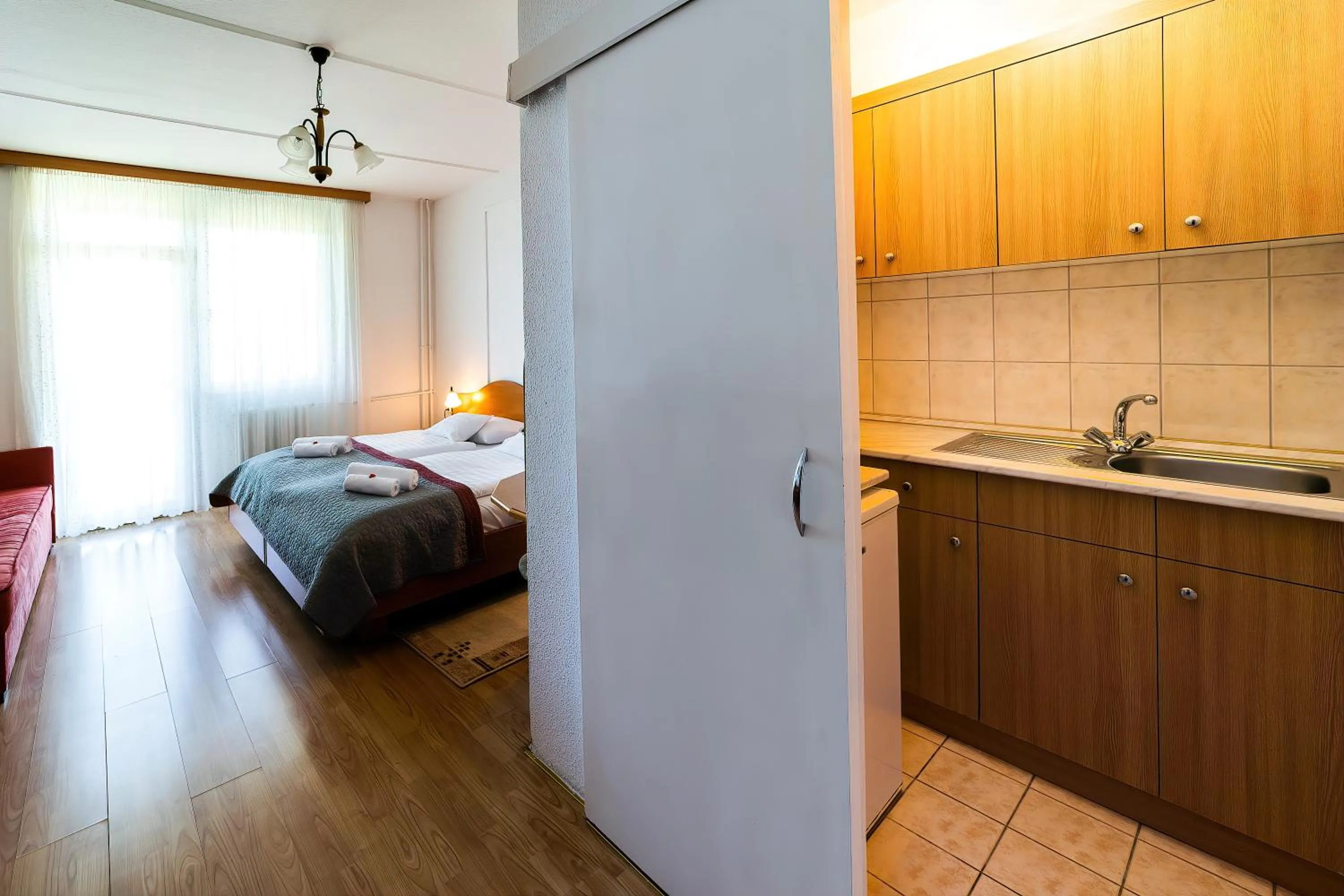 Kitchen or kitchenette, Bed in Napfény Hotel
