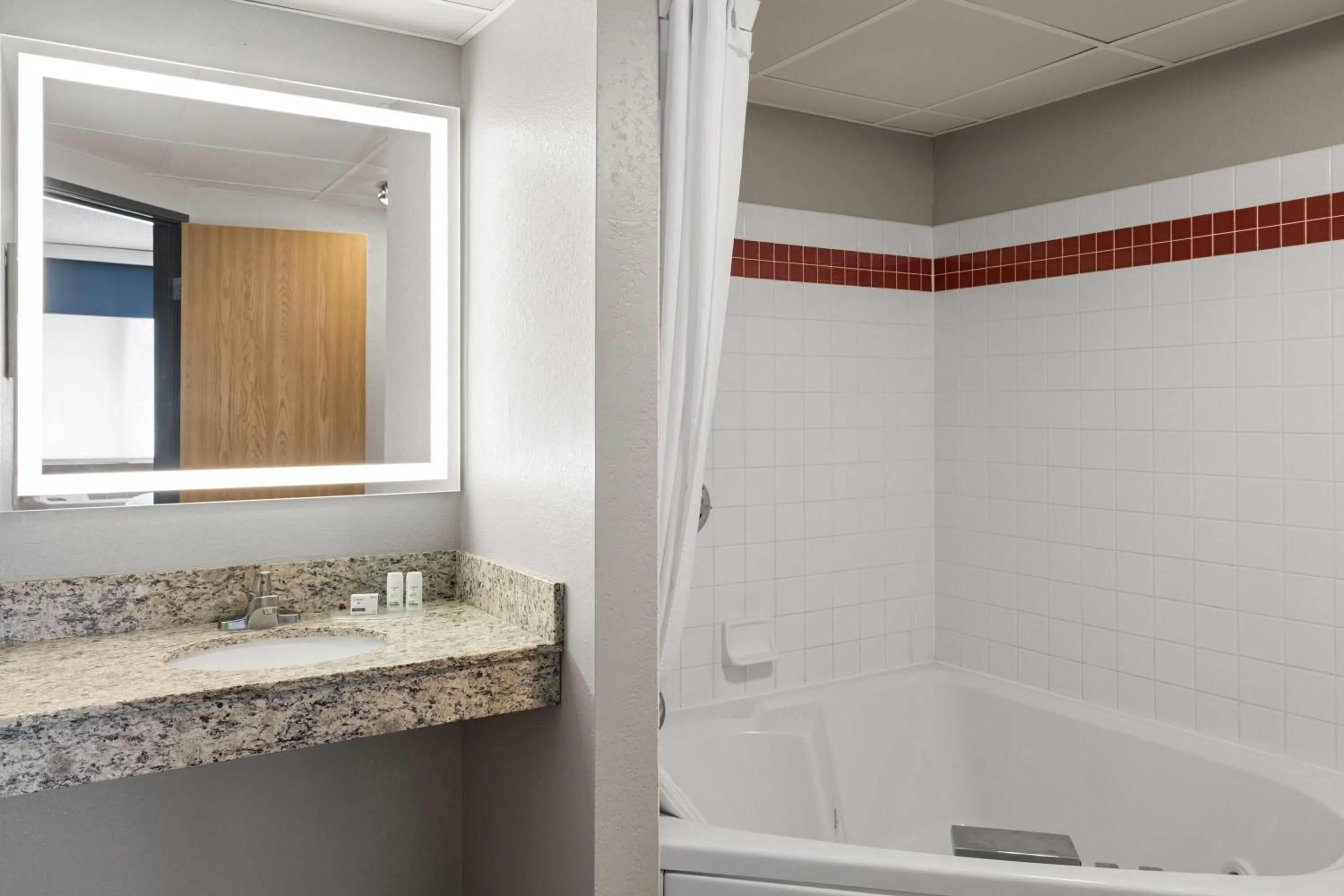 Bathroom in AmericInn by Wyndham Alexandria