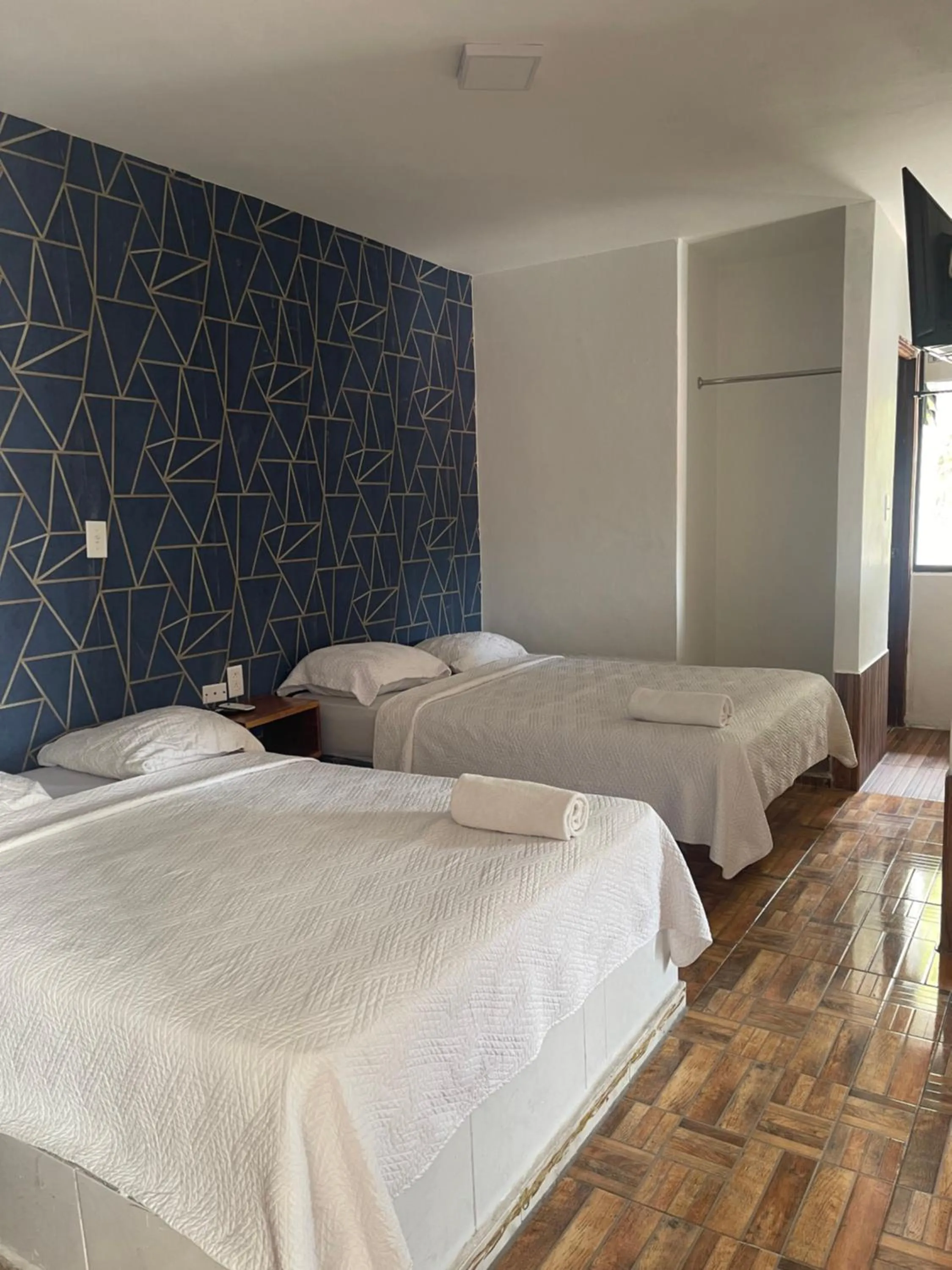 Bed in Hotel Costa Inn