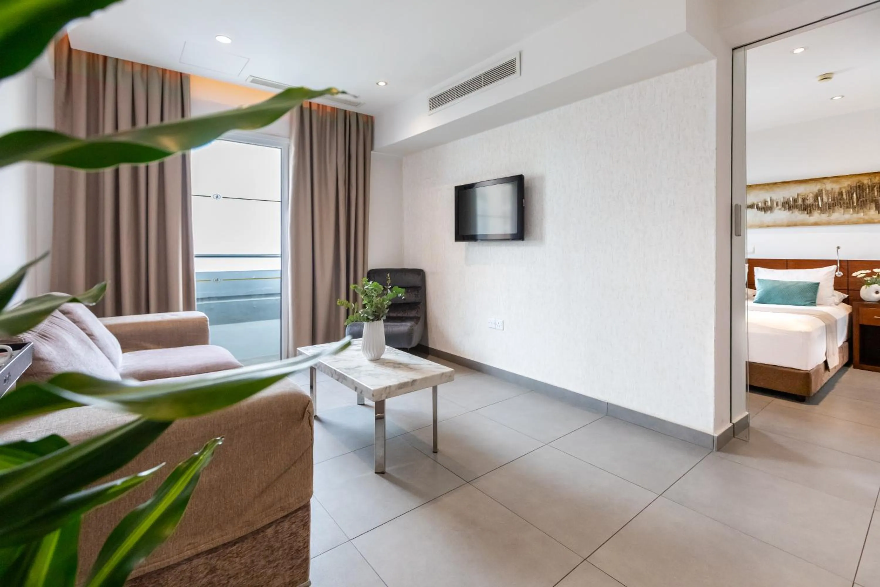 Communal lounge/ TV room, Bed in Achilleos City Hotel