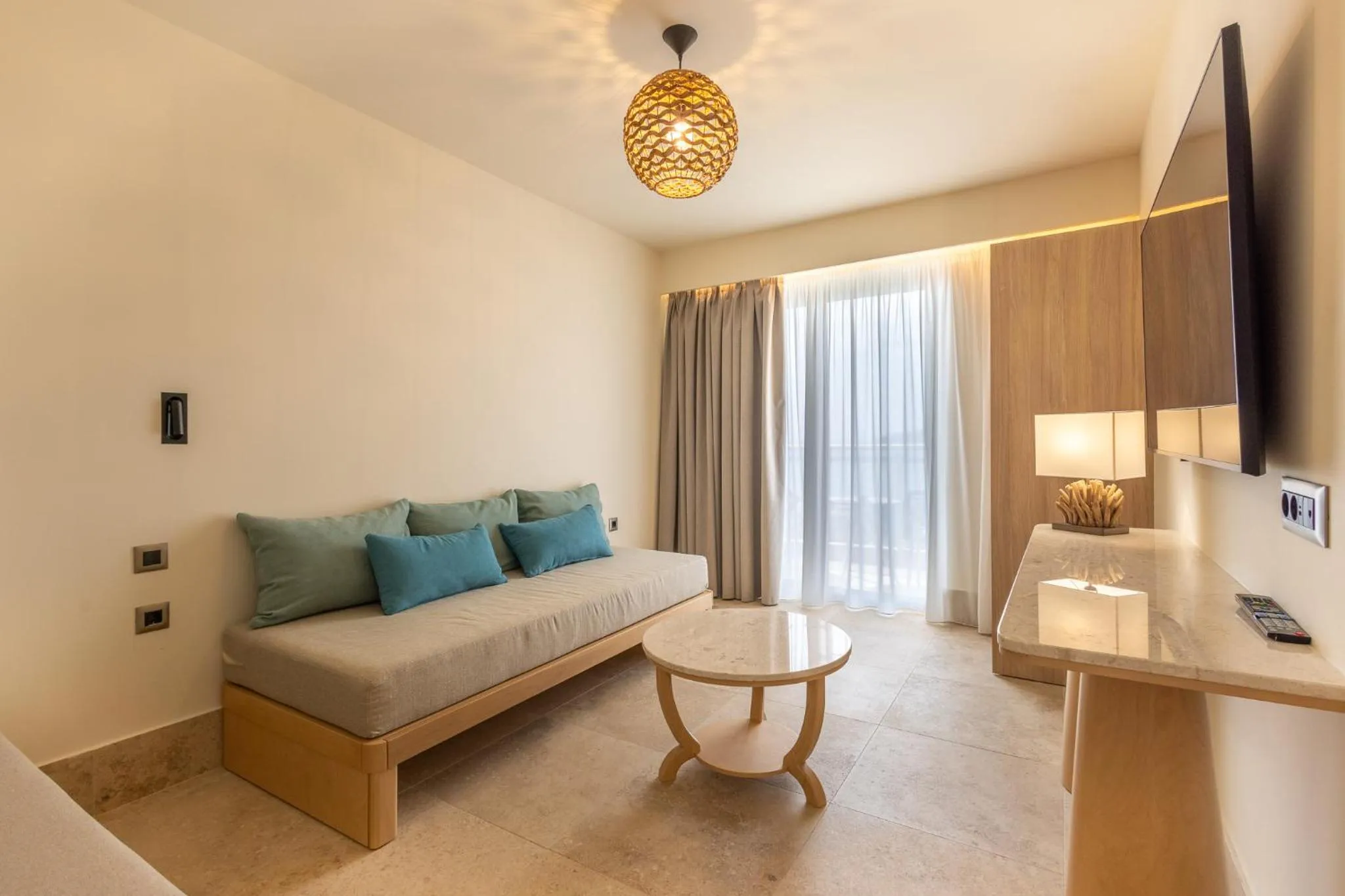 Living room, Bed in Pegasos Deluxe Beach Hotel