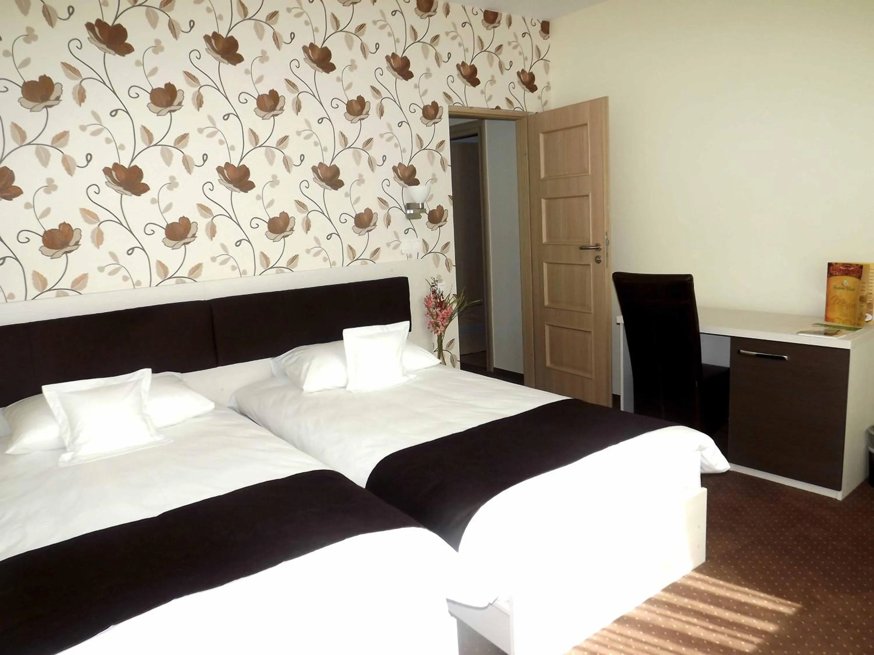 Bed in West Plaza Hotel