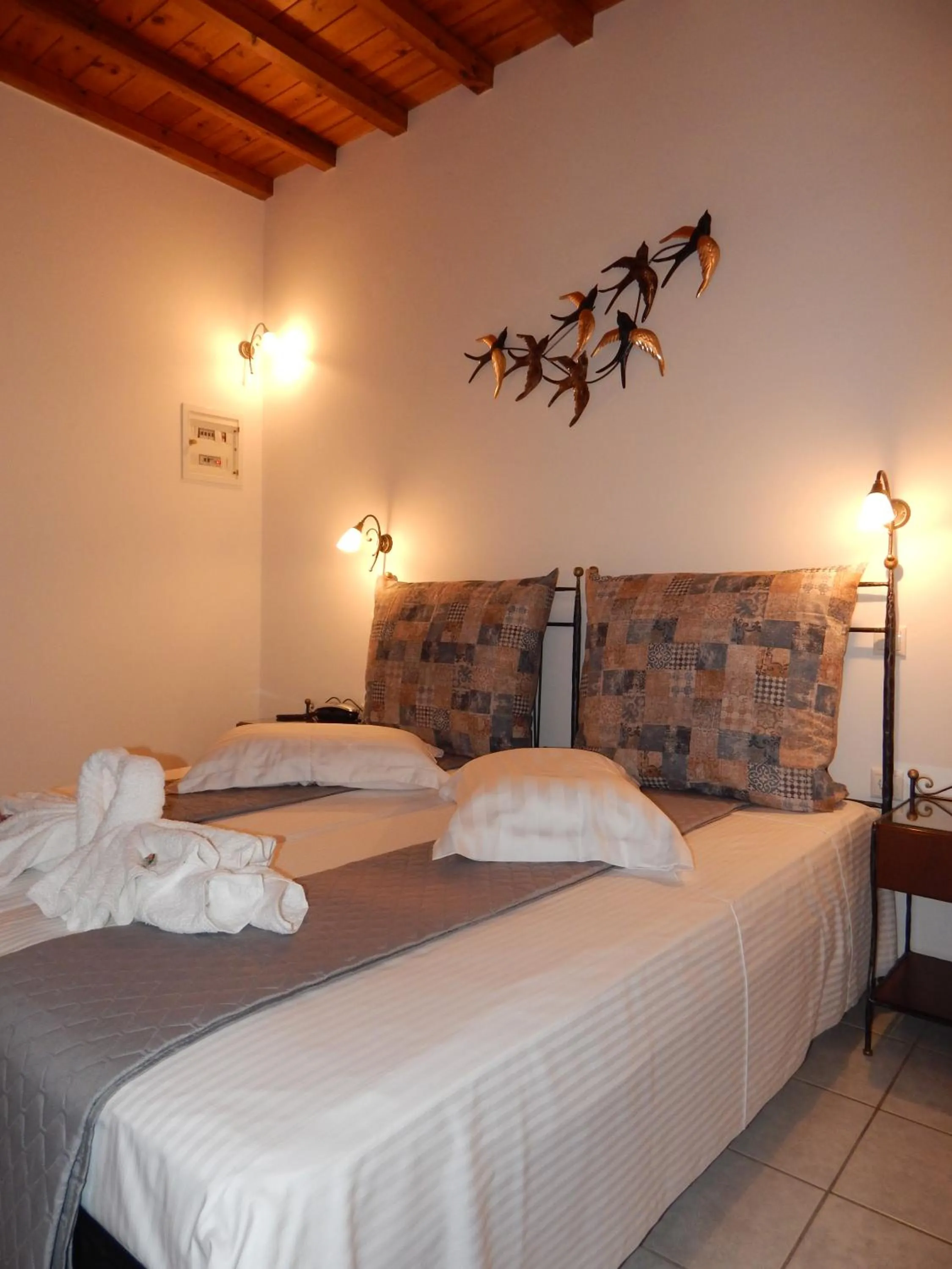 Bed in Tinos Suites & Apartments