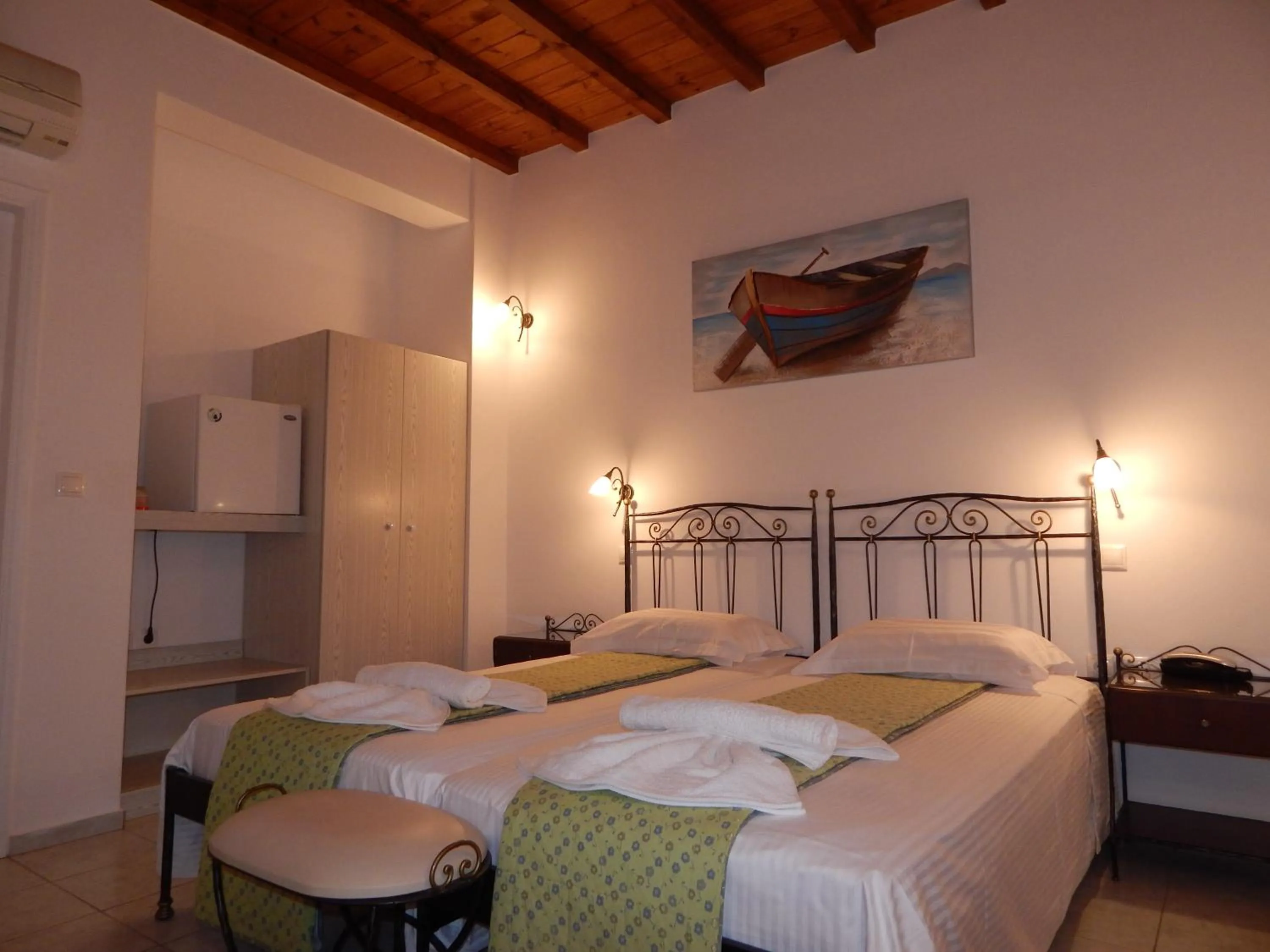 Bed in Tinos Suites & Apartments