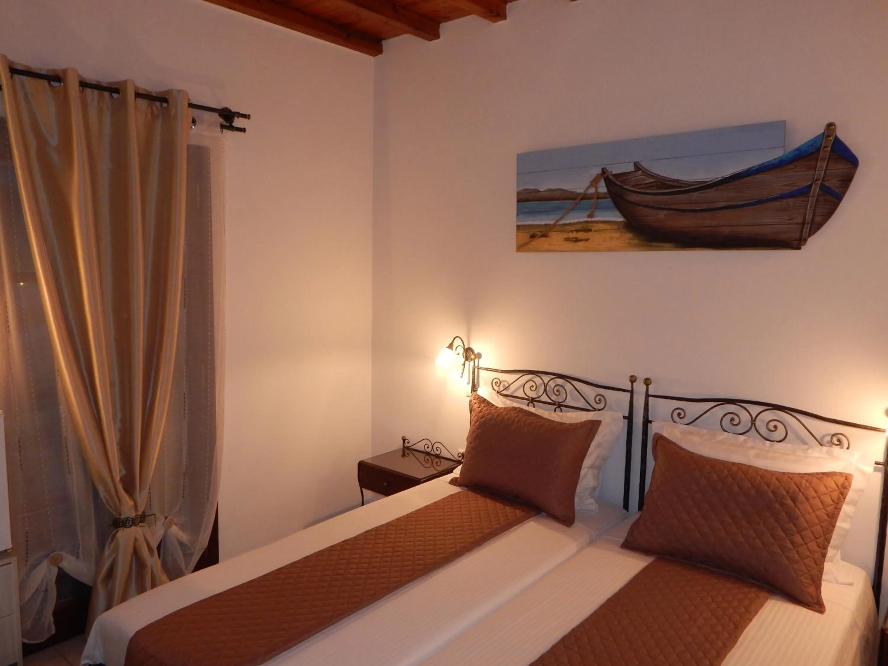 Bed in Tinos Suites & Apartments