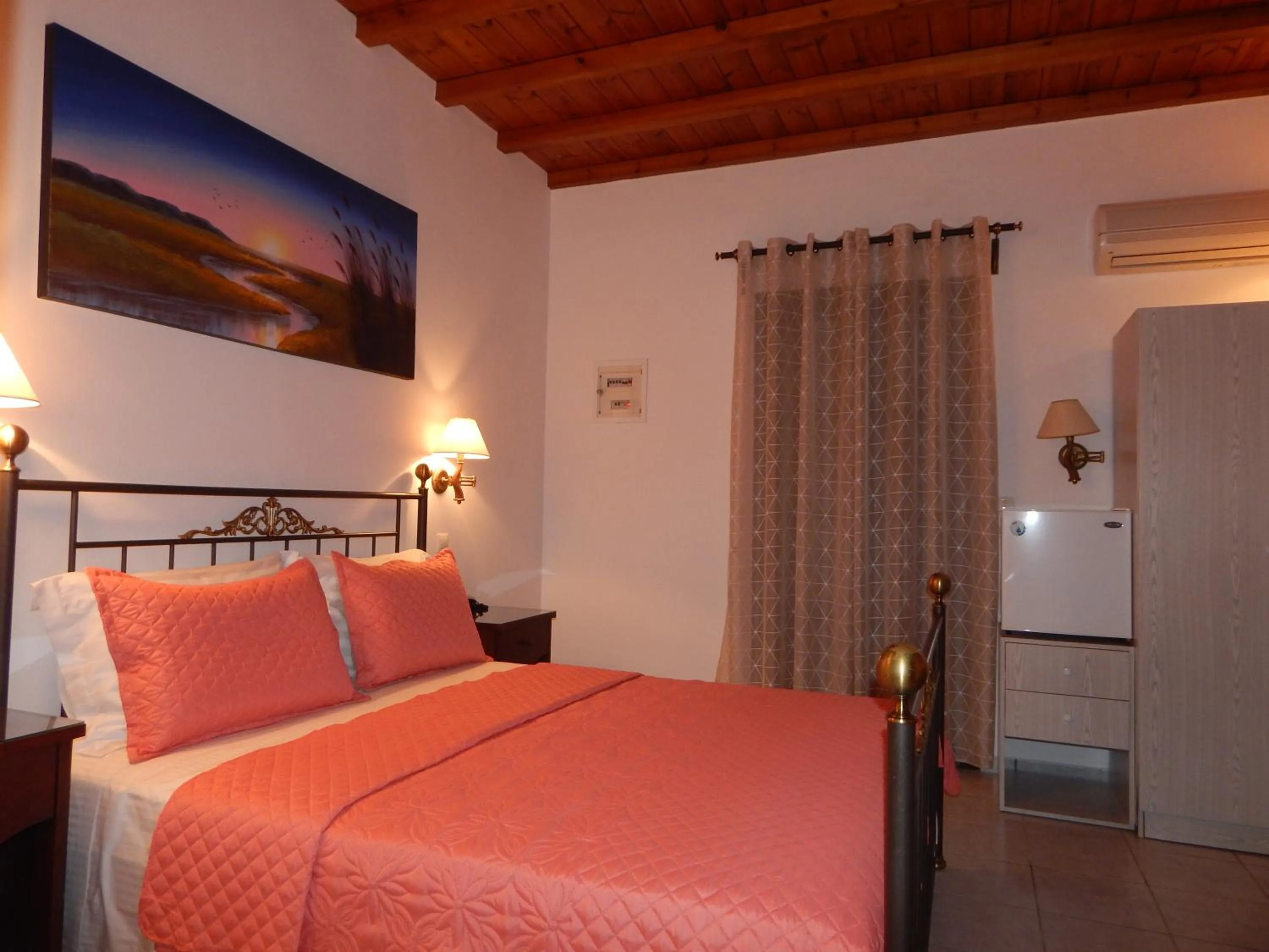 Bed in Tinos Suites & Apartments