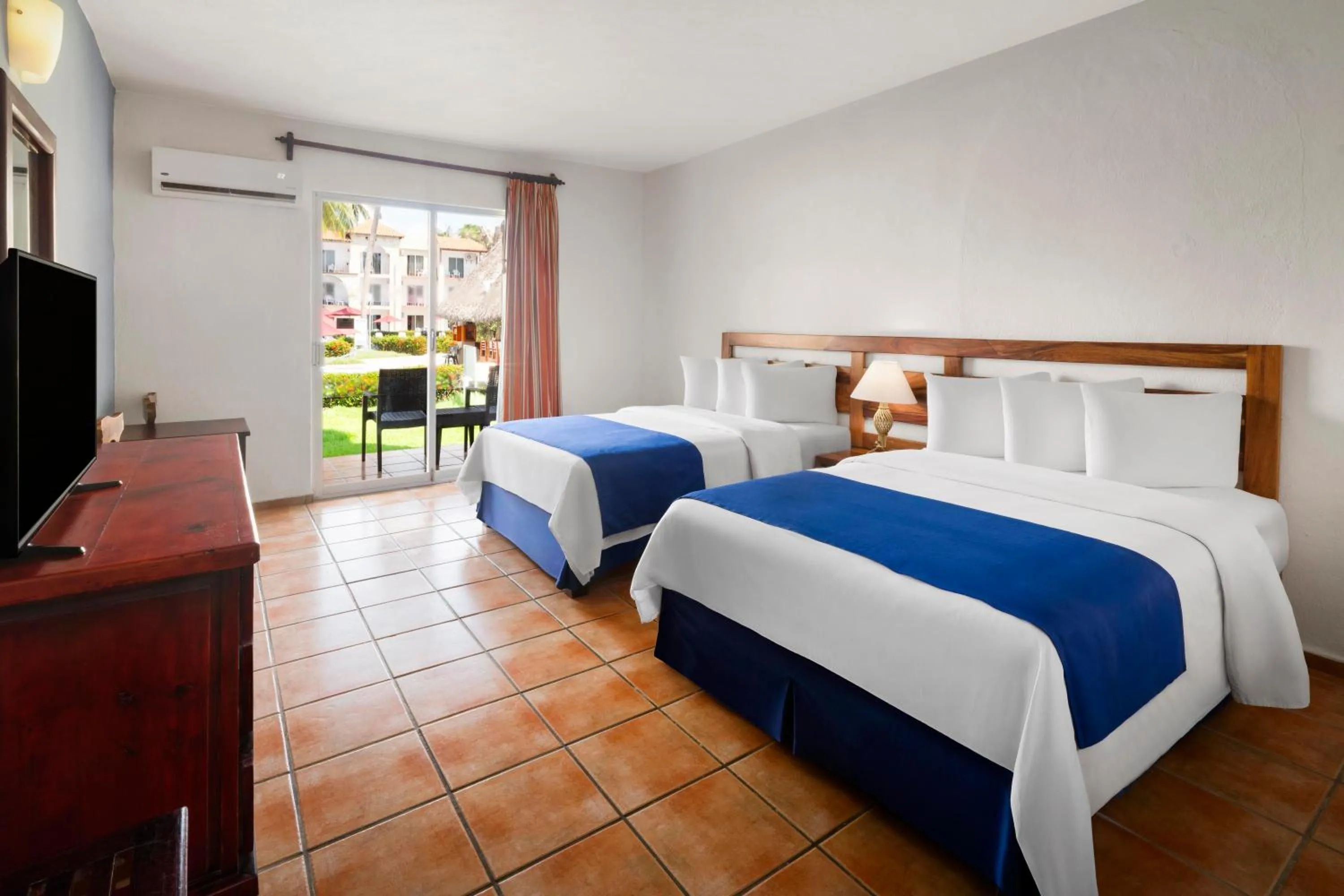 Bed in Grand Decameron Complex Bucerias, A Trademark All-Inclusive Resort