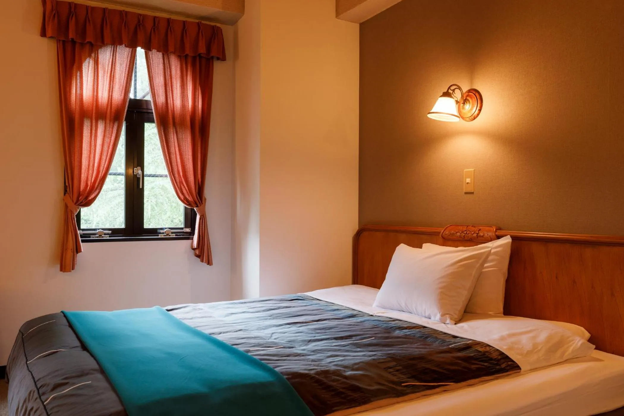 Bed in ホテルけやきの樹