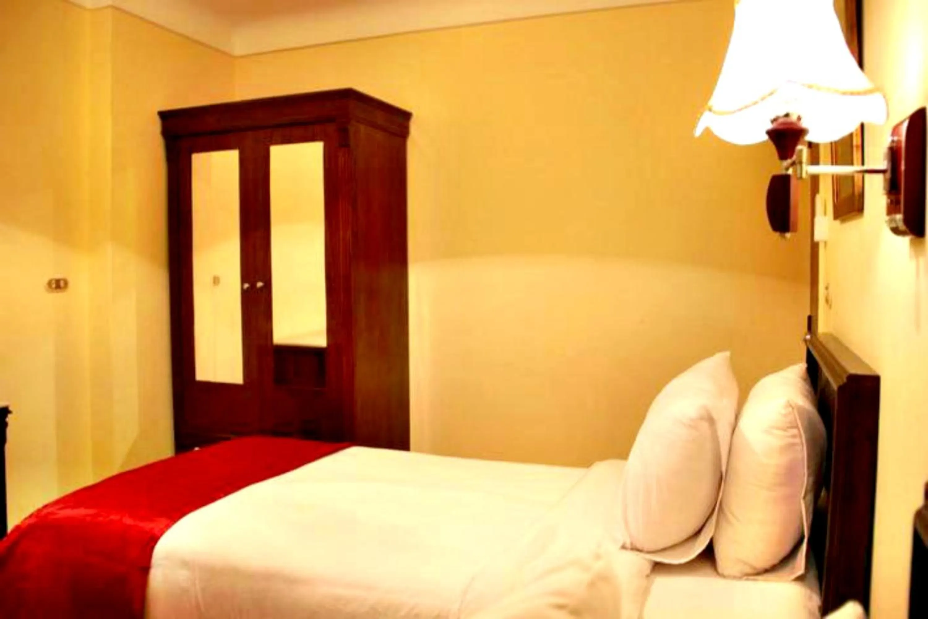 Bed in Alexandria Mediterranean Suites