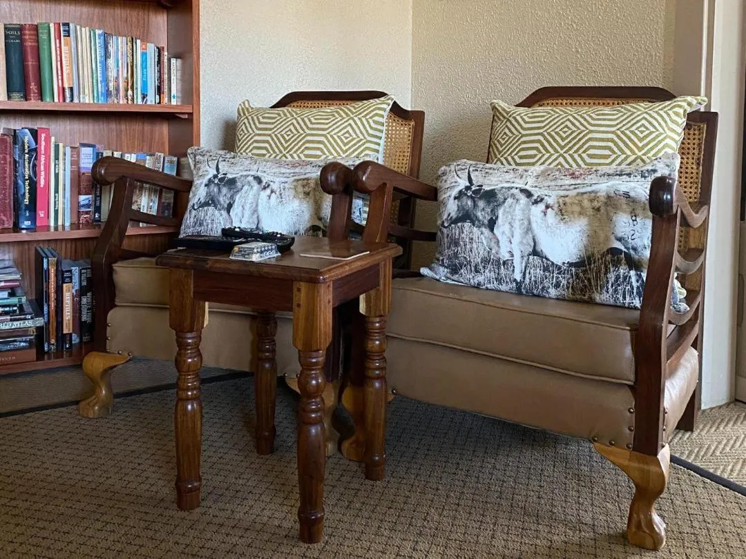 Communal lounge/ TV room, Bed in Goibib Mountain Lodge