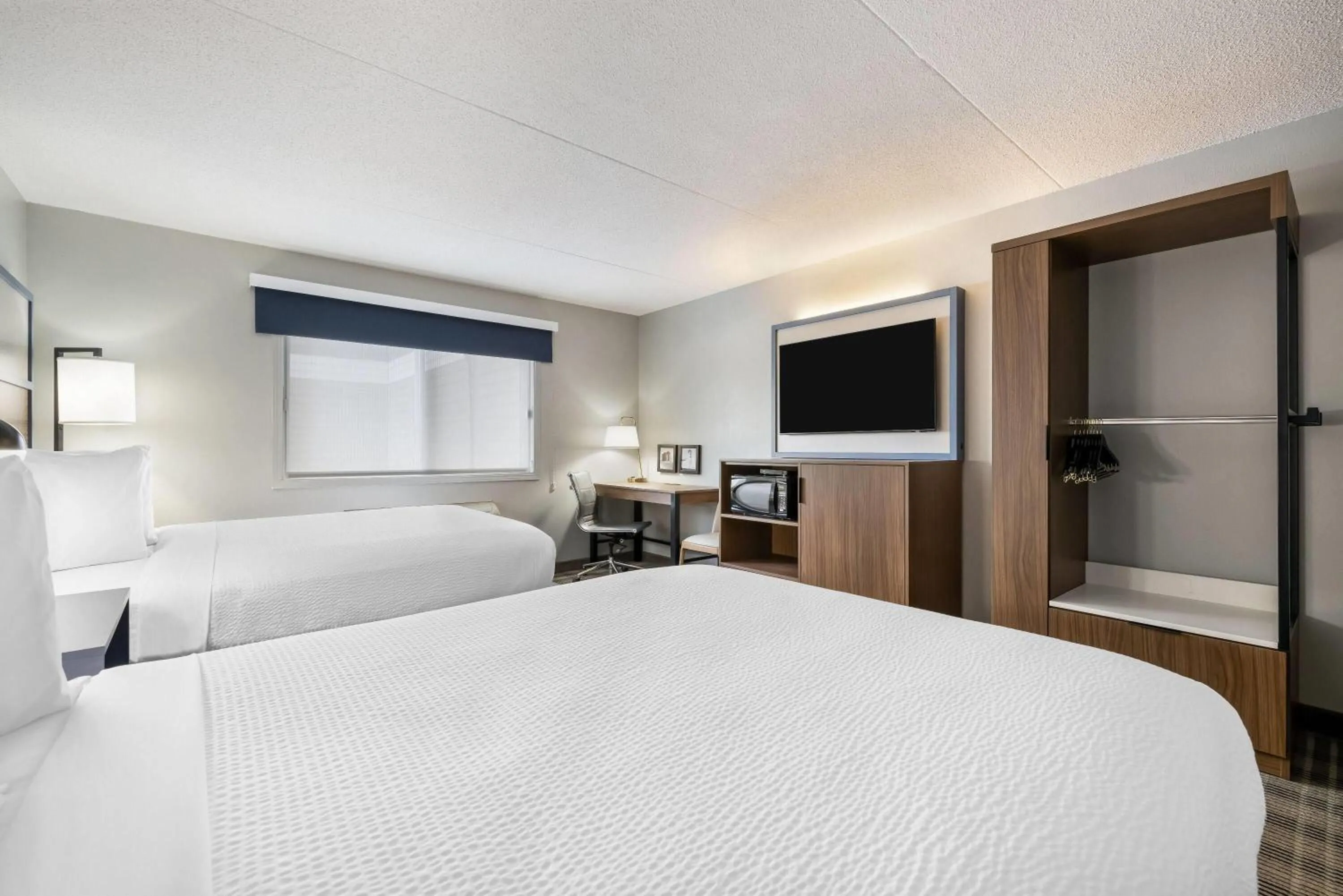 Bed in AmericInn by Wyndham Valley City Conference Center