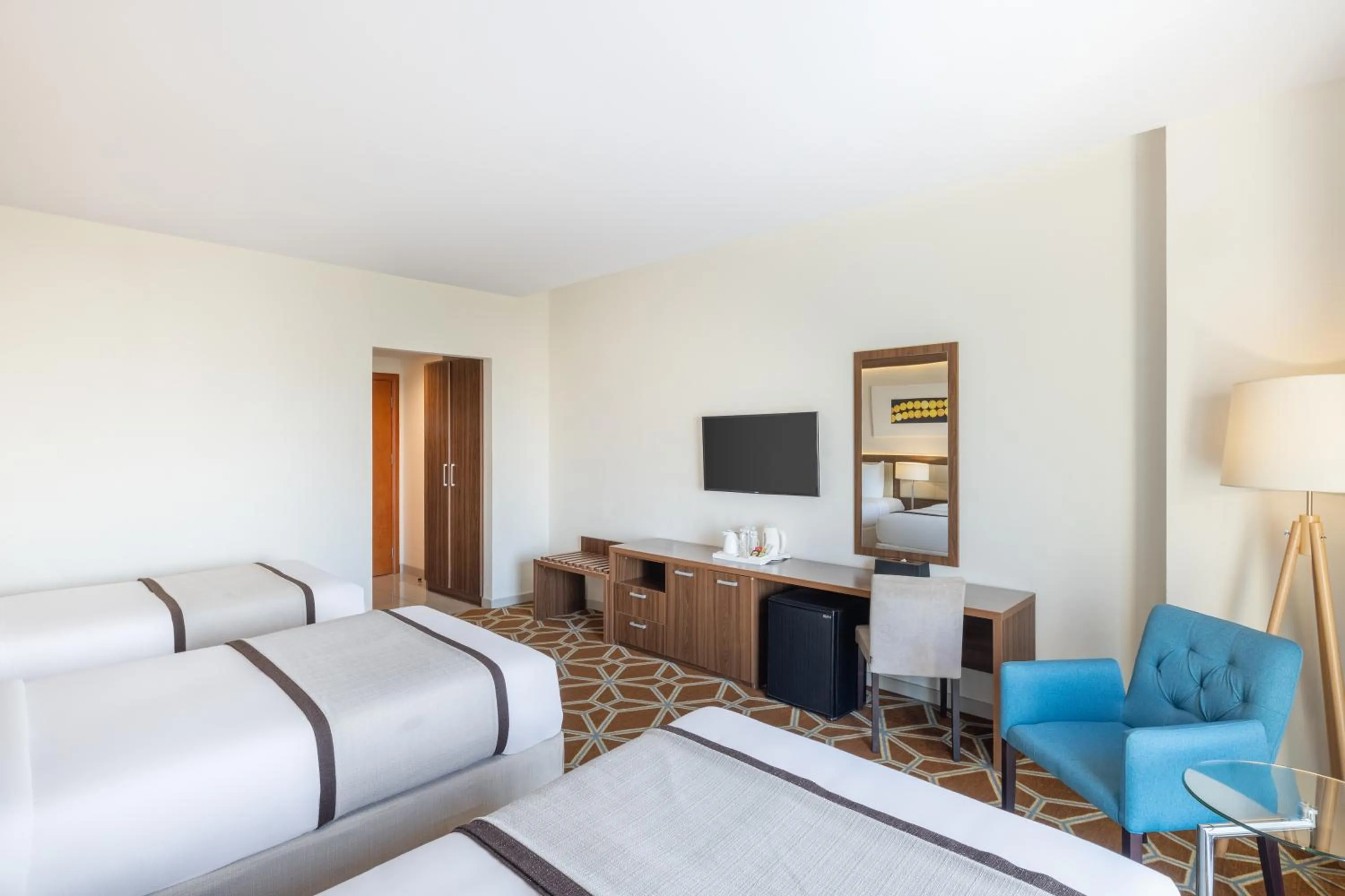 Communal lounge/ TV room, Bed in Blue Coral Hotel