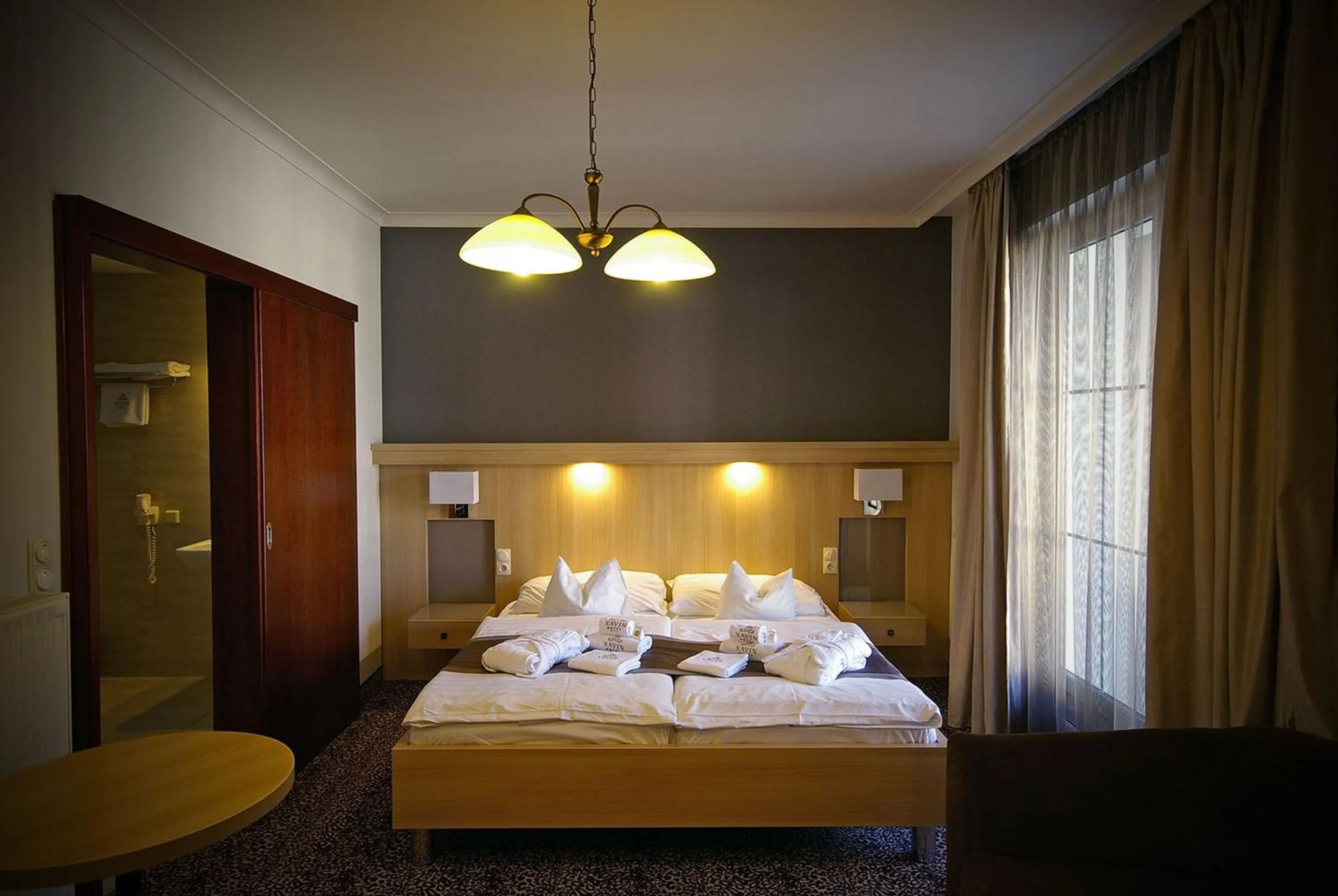 Bed in Xavin Wellness Hotel & Restaurant