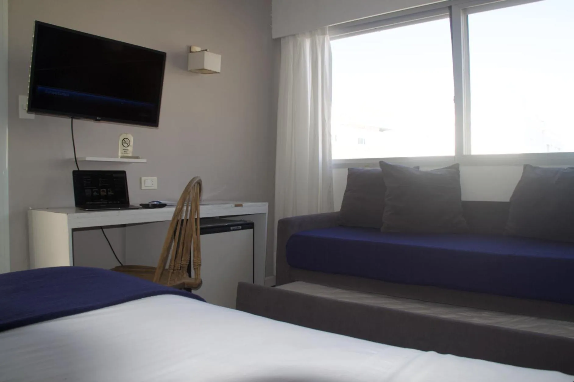 Communal lounge/ TV room, Bed in Hotel Milano