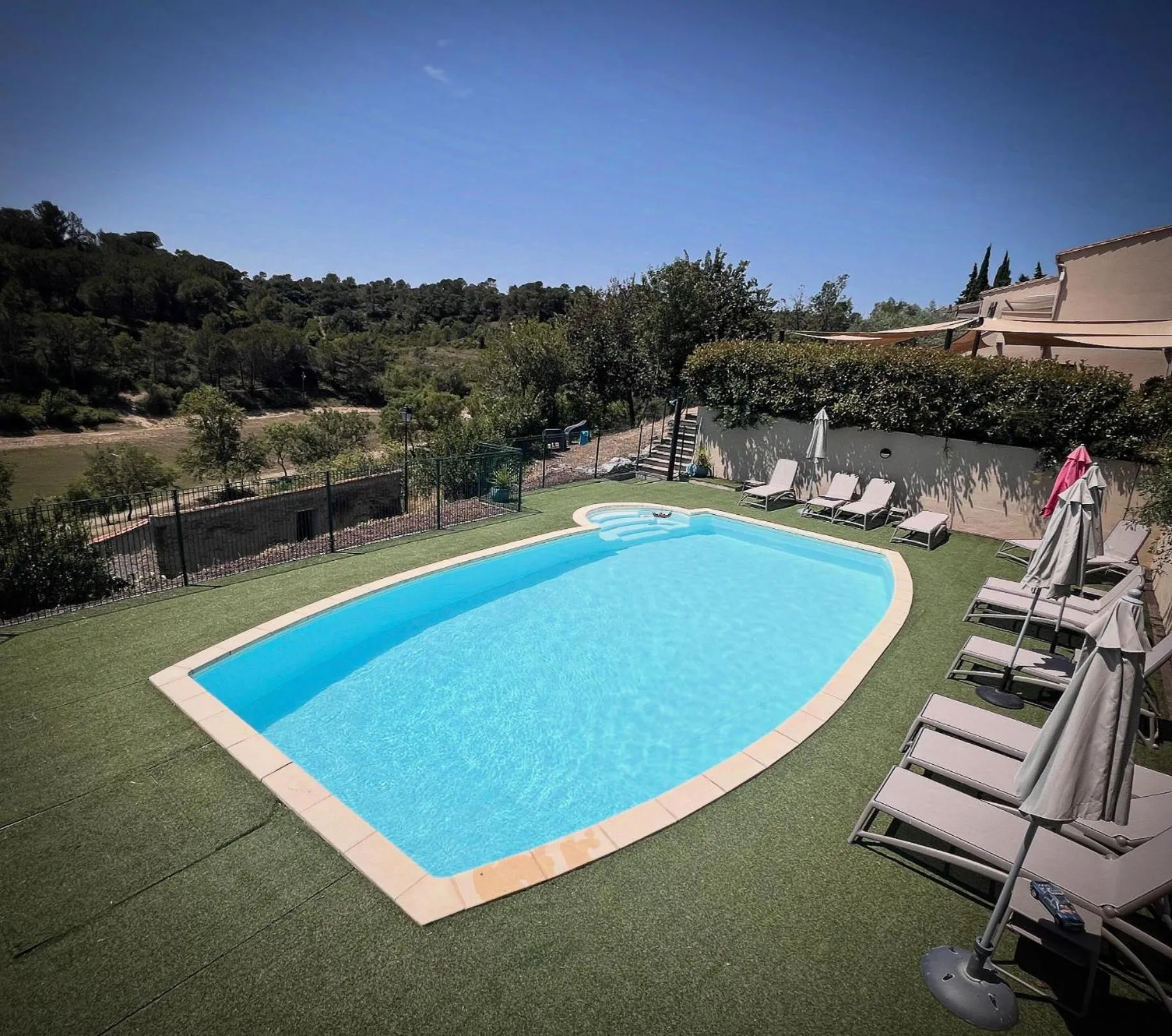Swimming pool in Logis Hôtel Restaurant La Bergerie